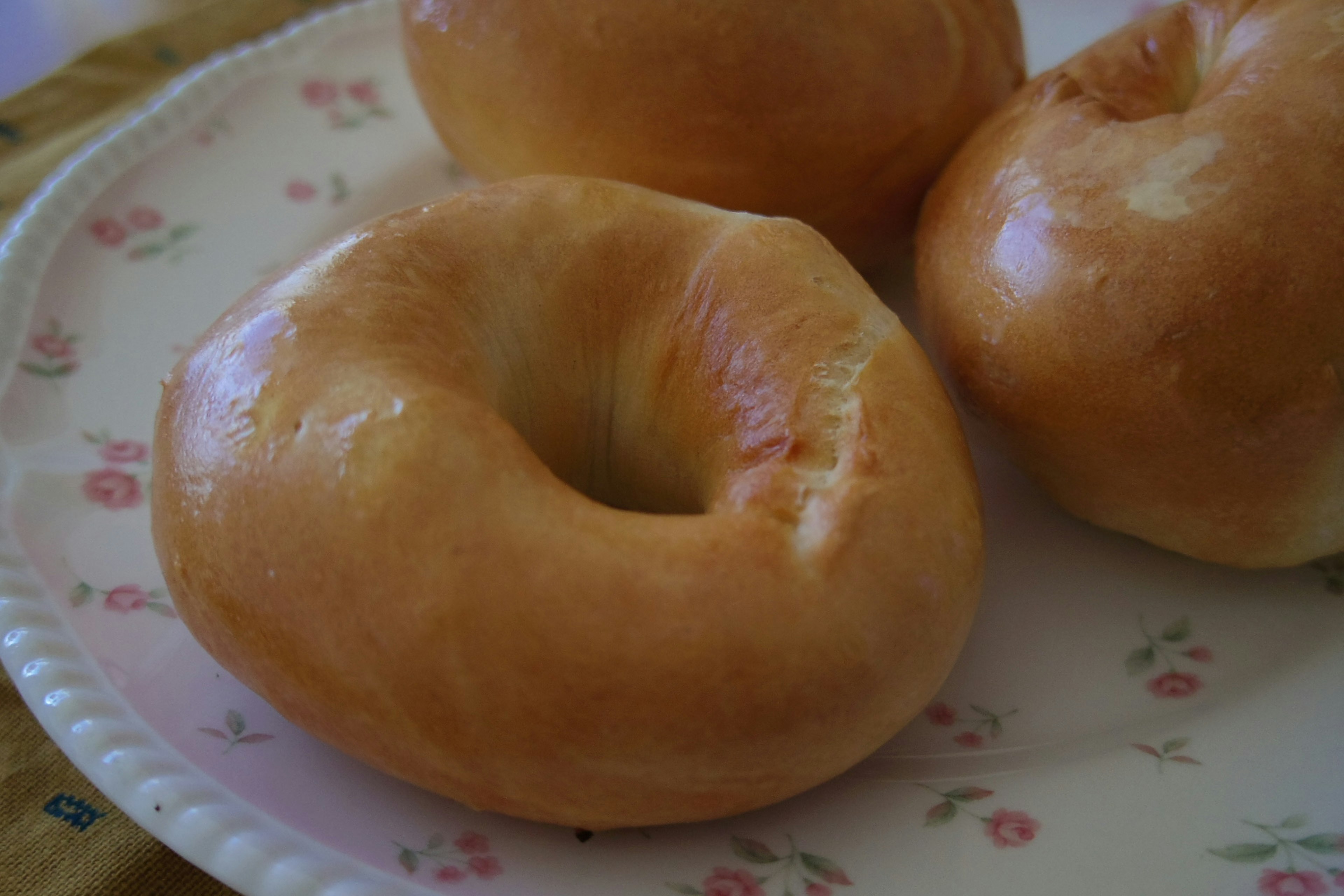 Freshly baked bagels arranged on a plate