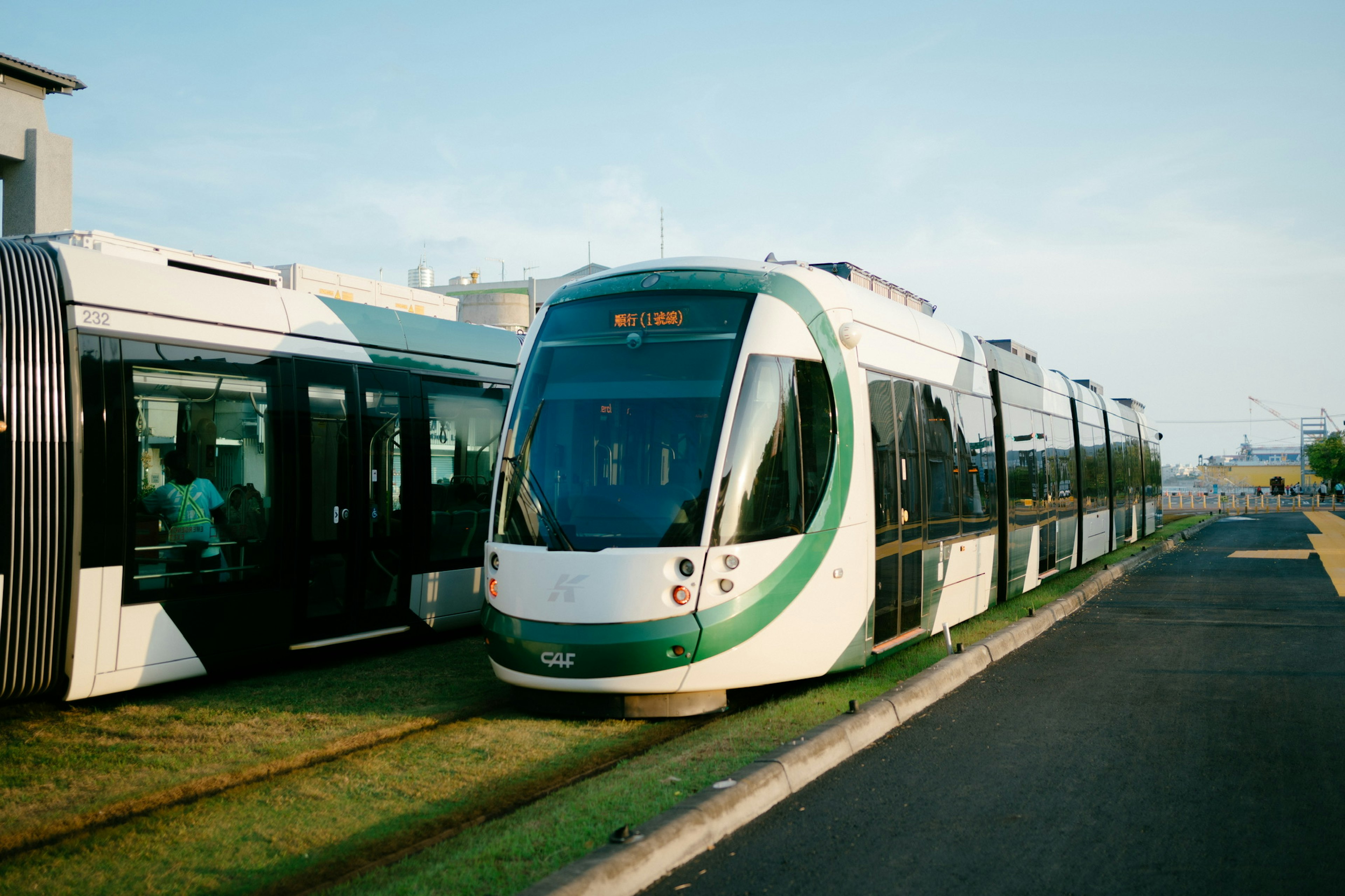 Tram with green stripes parked at the station