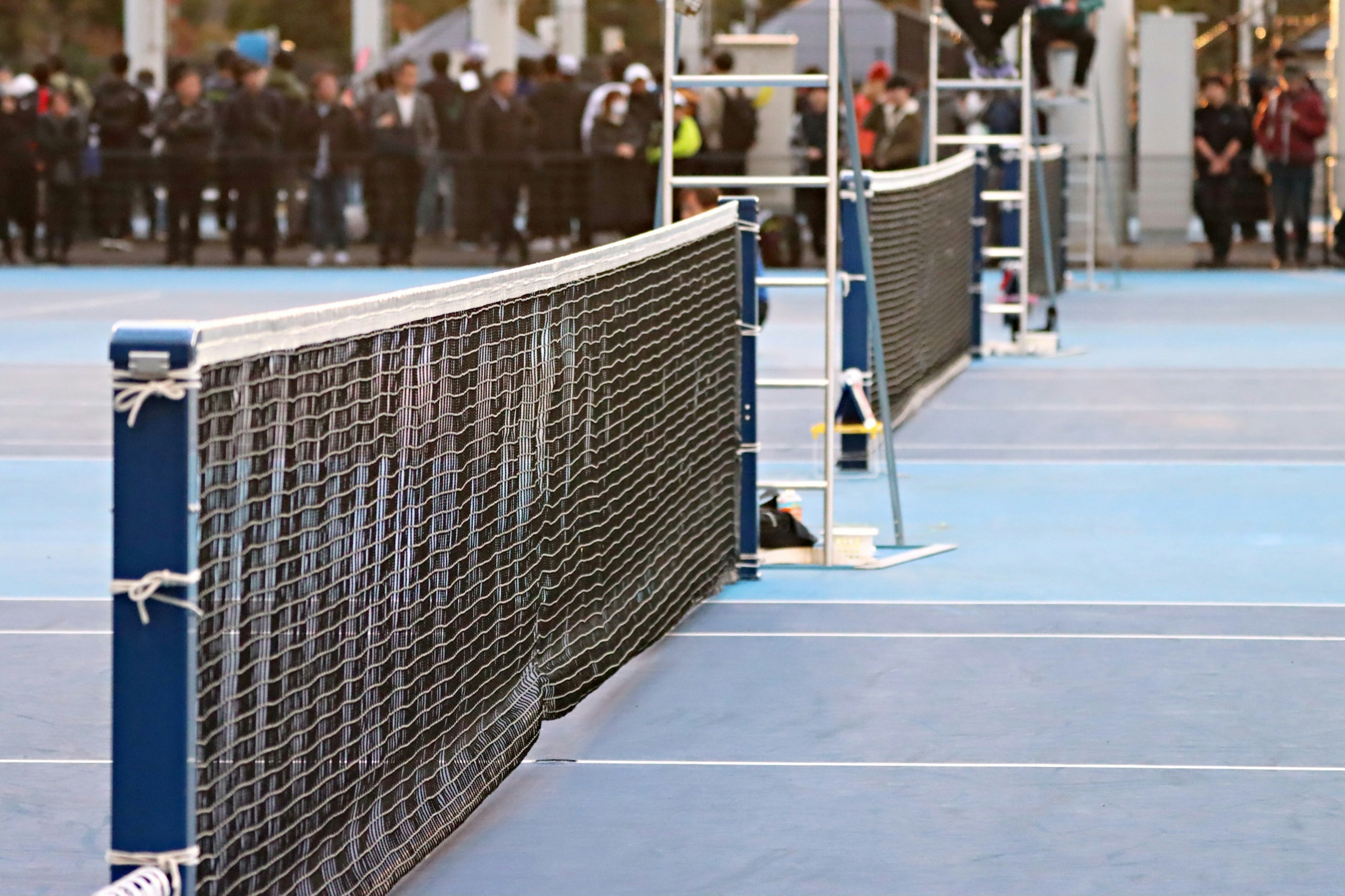 Tennis court with net and blue surface