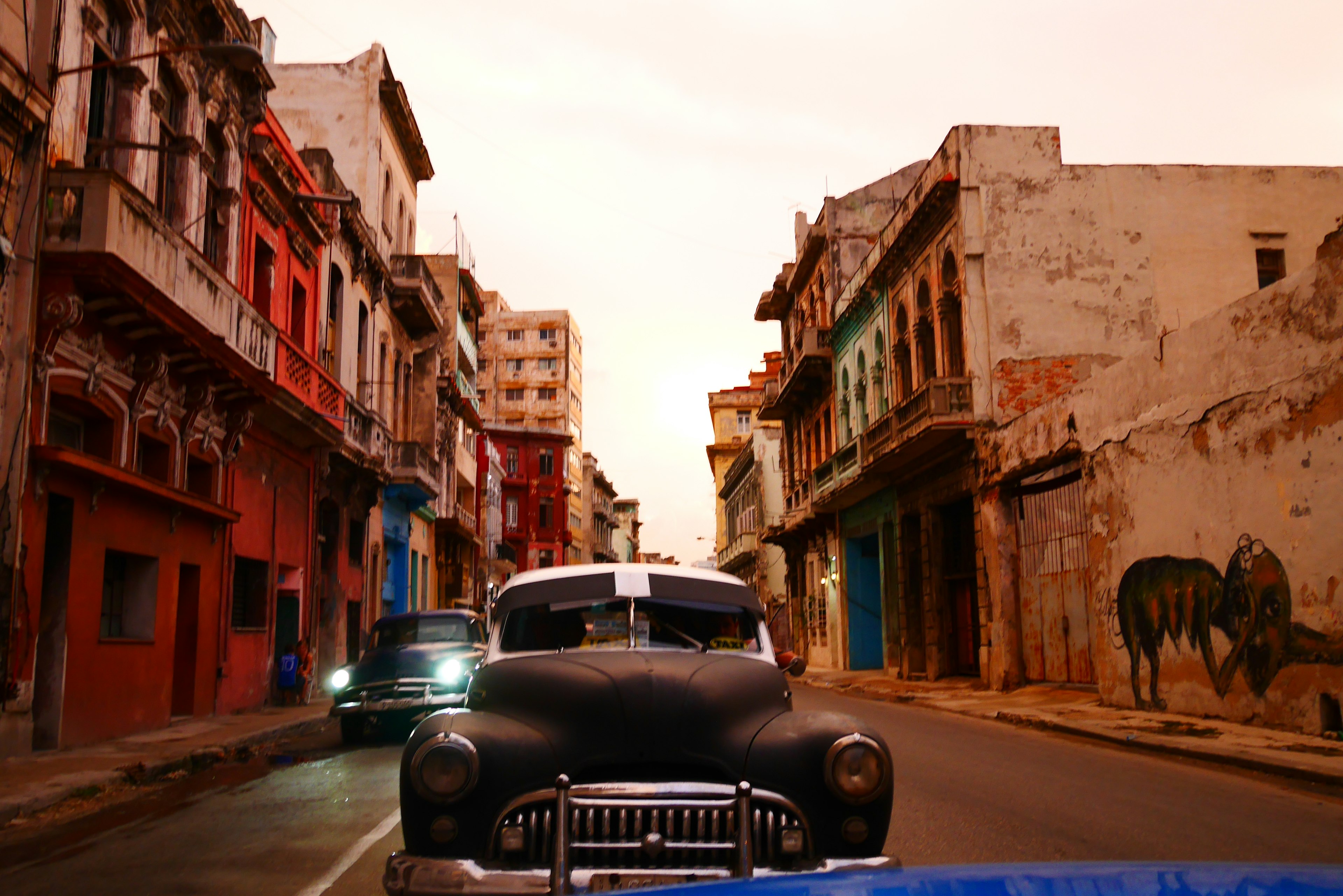 Colorful old buildings and a classic car in the streets of Havana