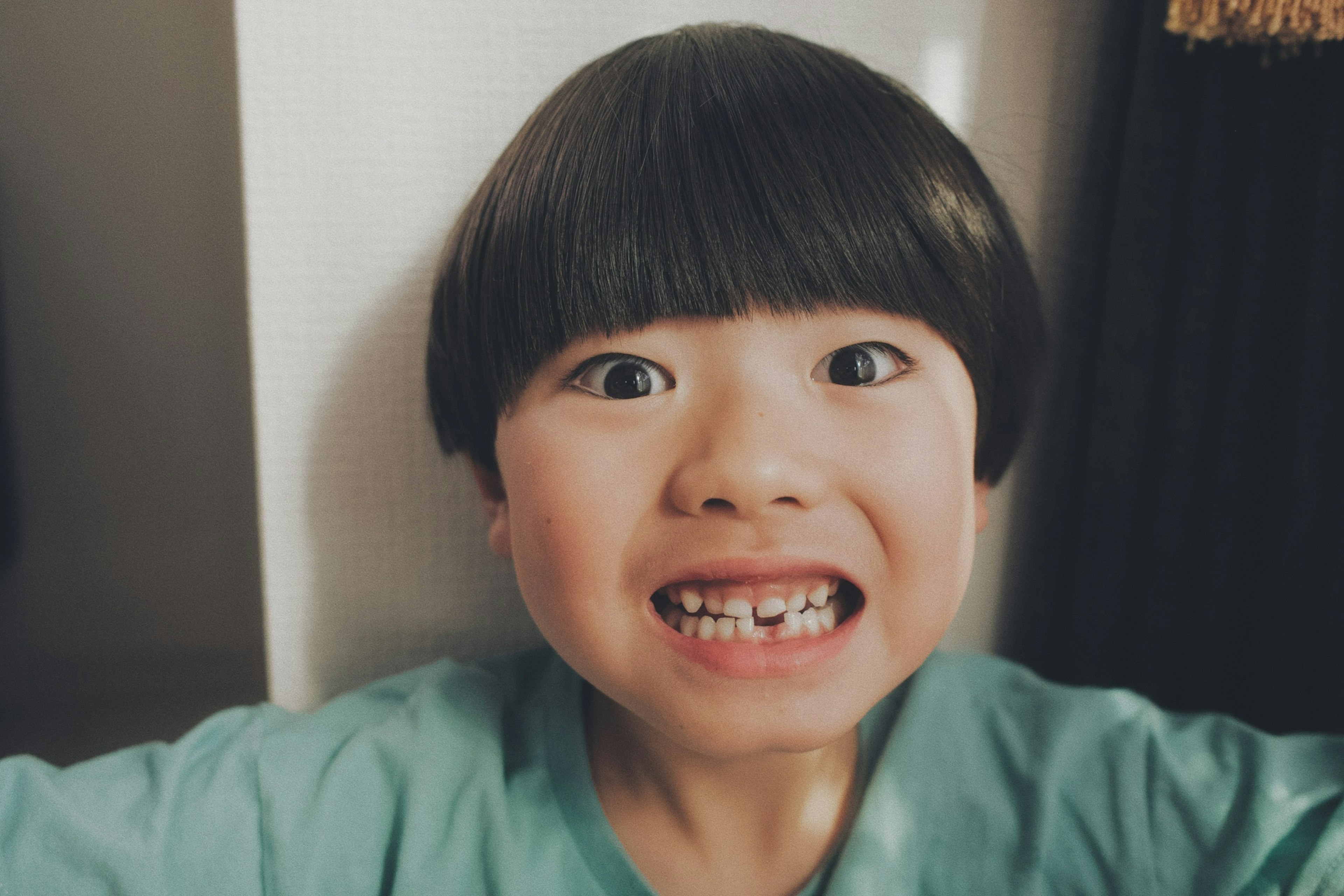 A smiling boy posing for the camera with a cheerful expression