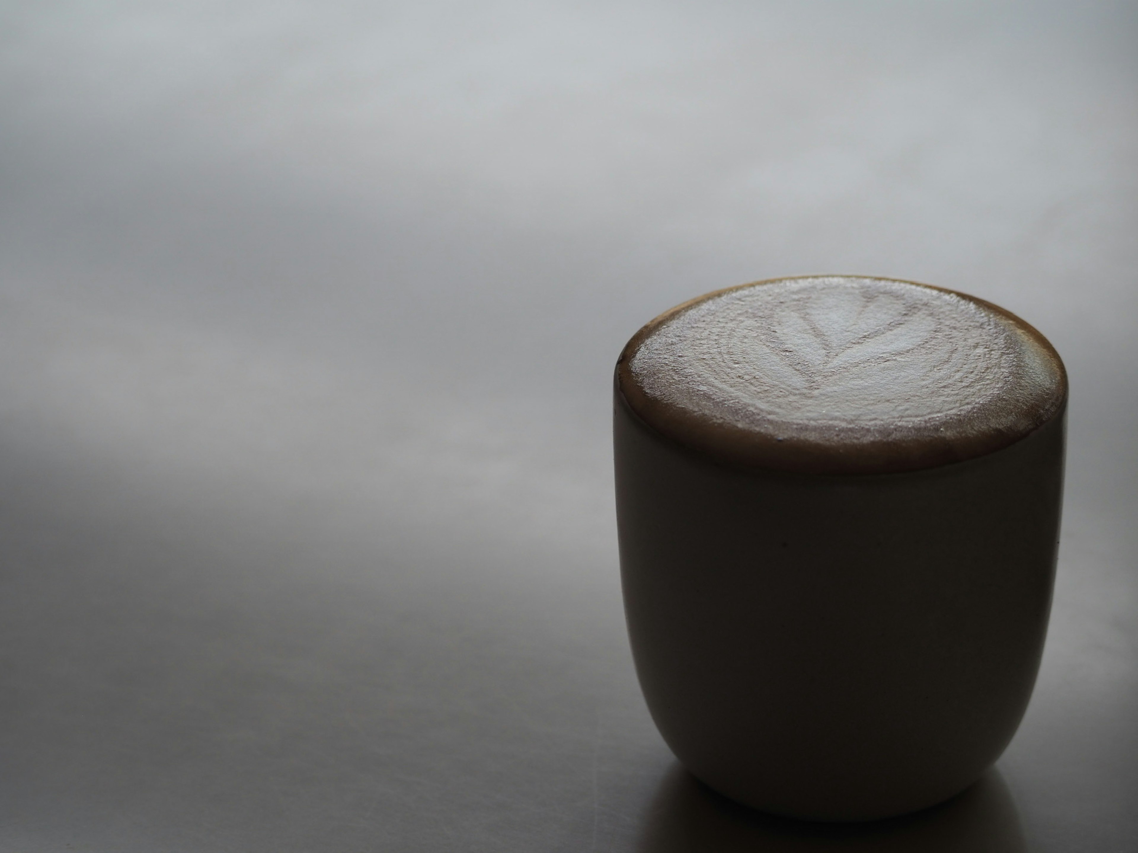 Coffee with latte art in a white cup