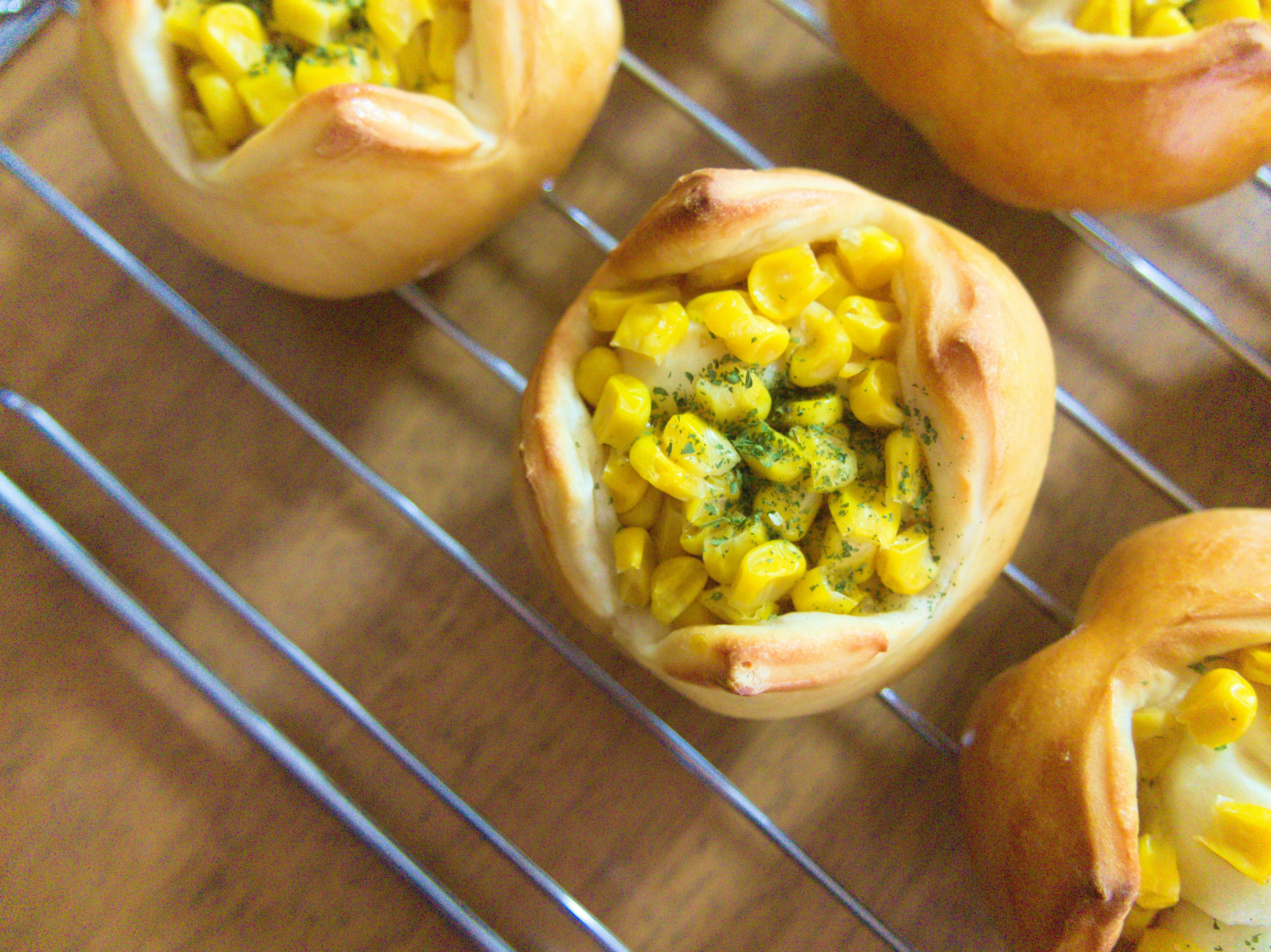 Freshly baked corn pastries on a cooling rack