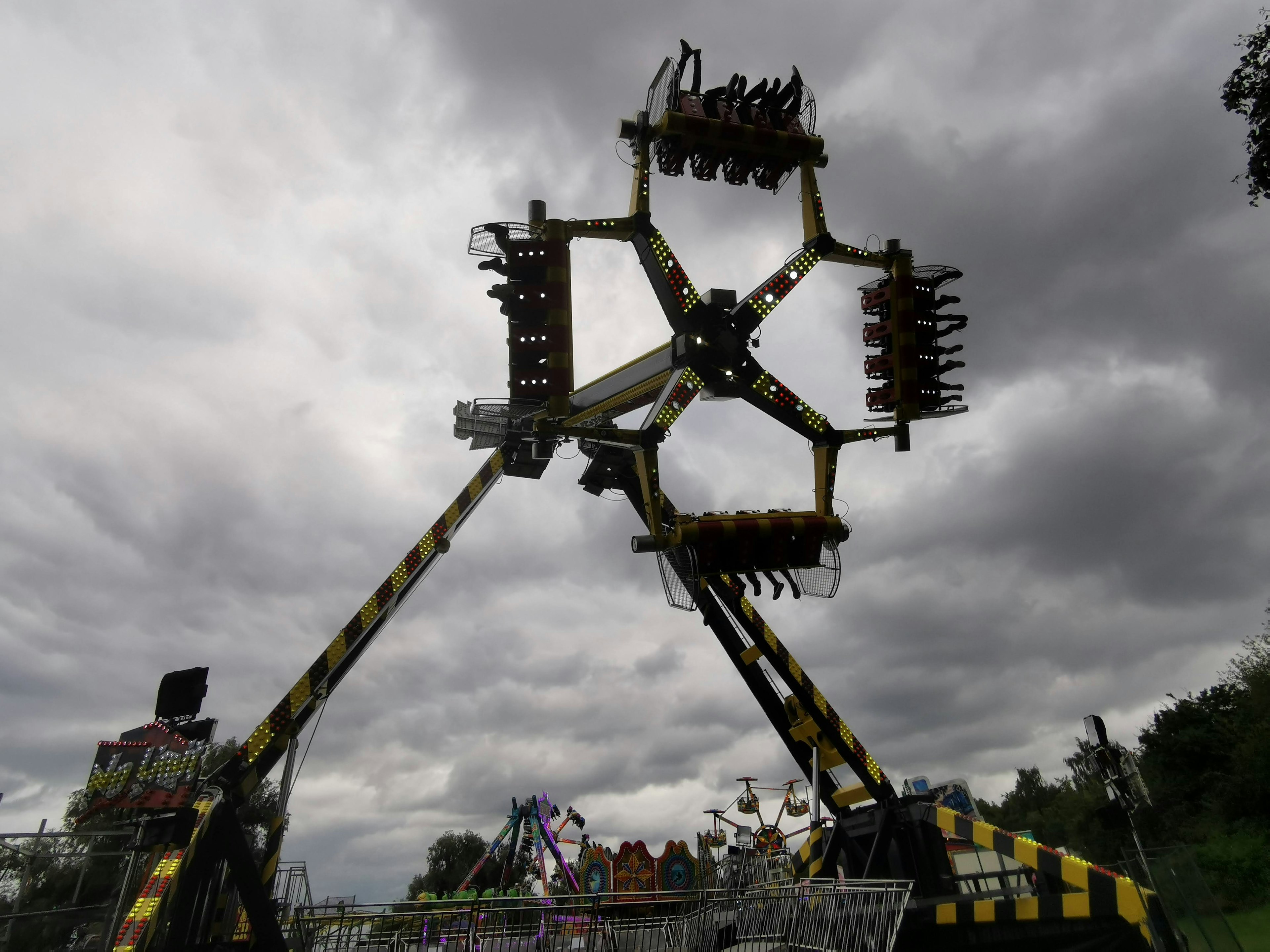 Thrilling amusement park ride under gray clouds