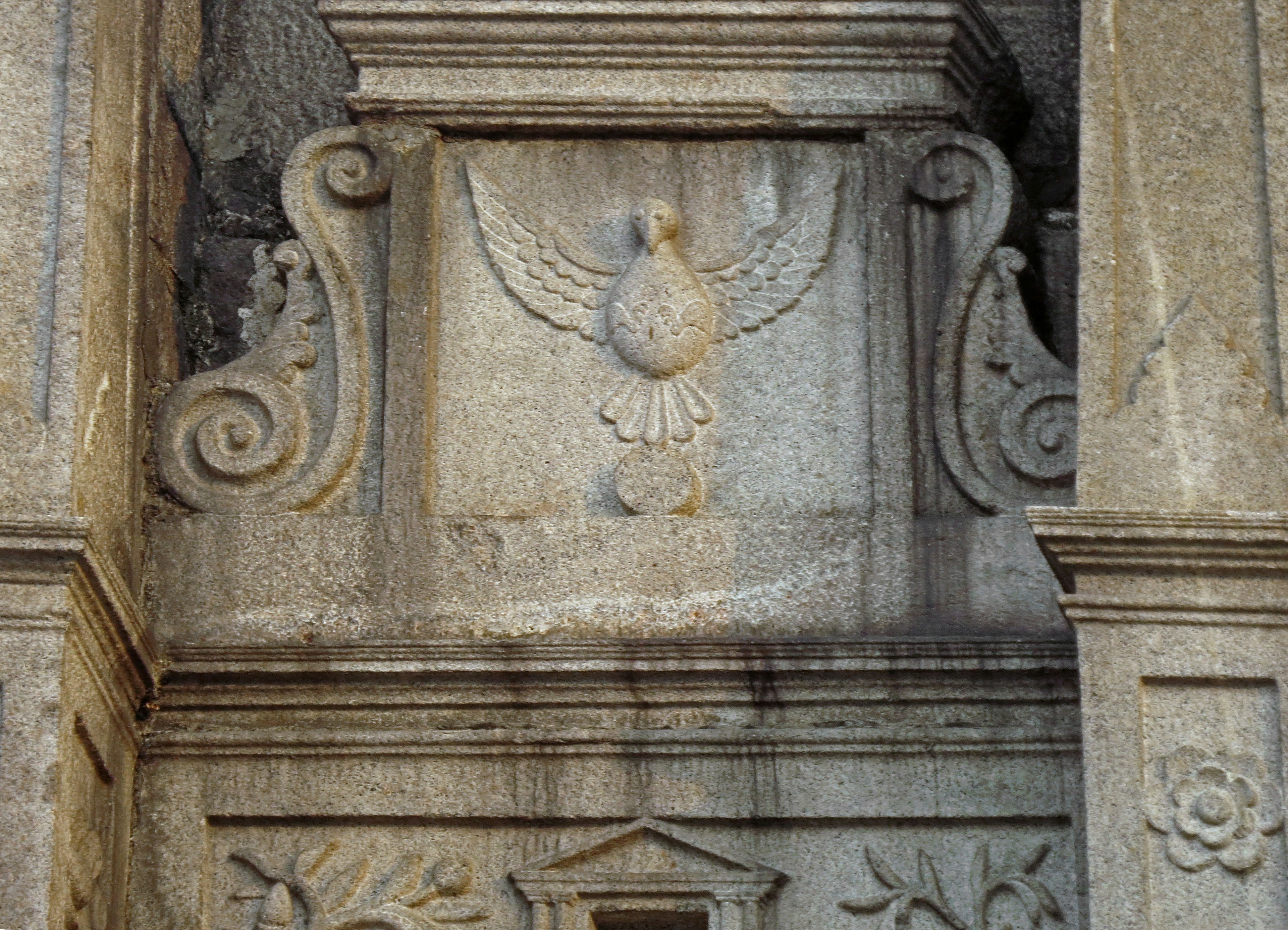 Carved stone wall featuring a design of a bird with wings