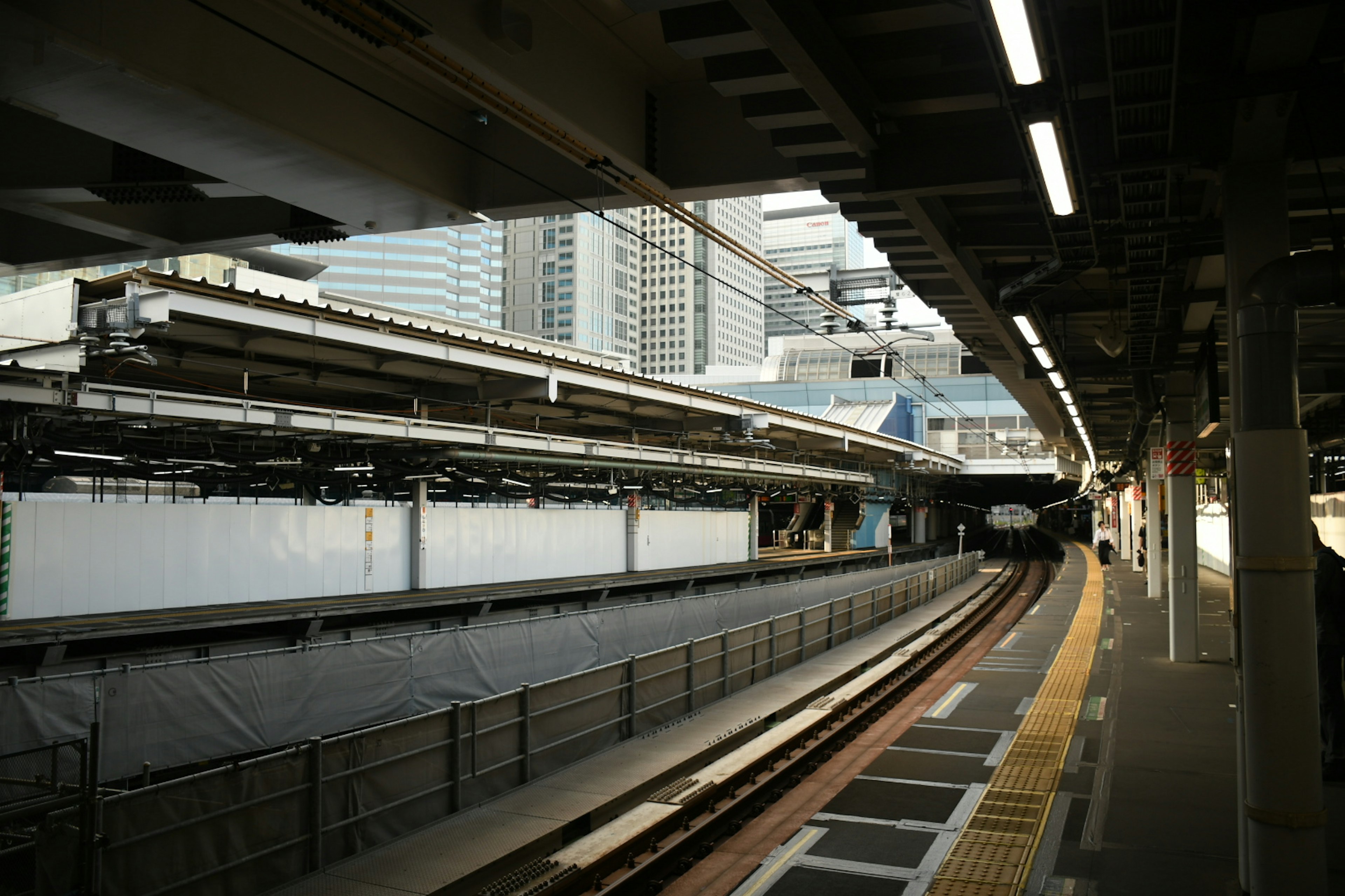 Modern train station platform with railway tracks