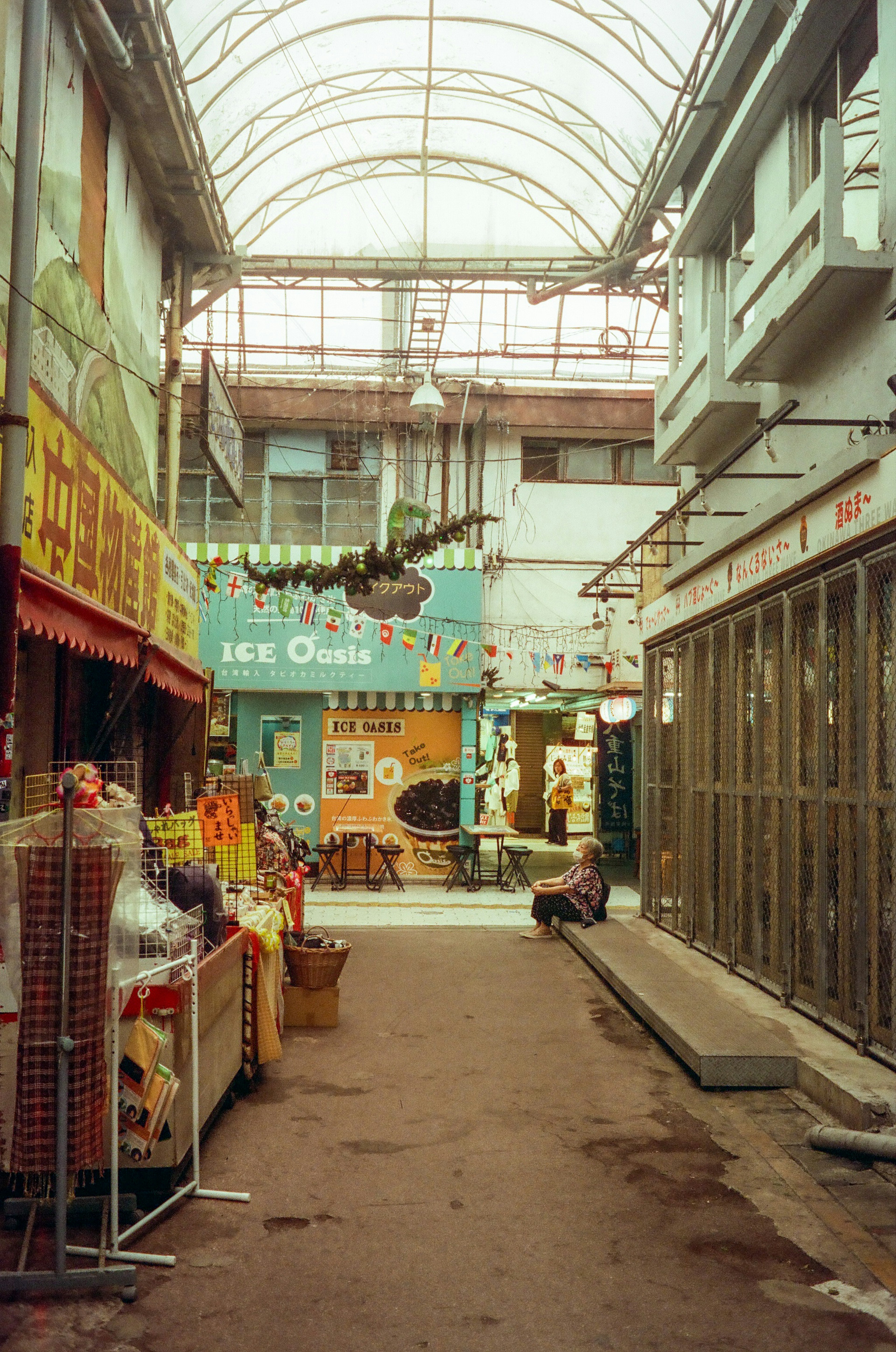 Covered market street with shops and colorful signs