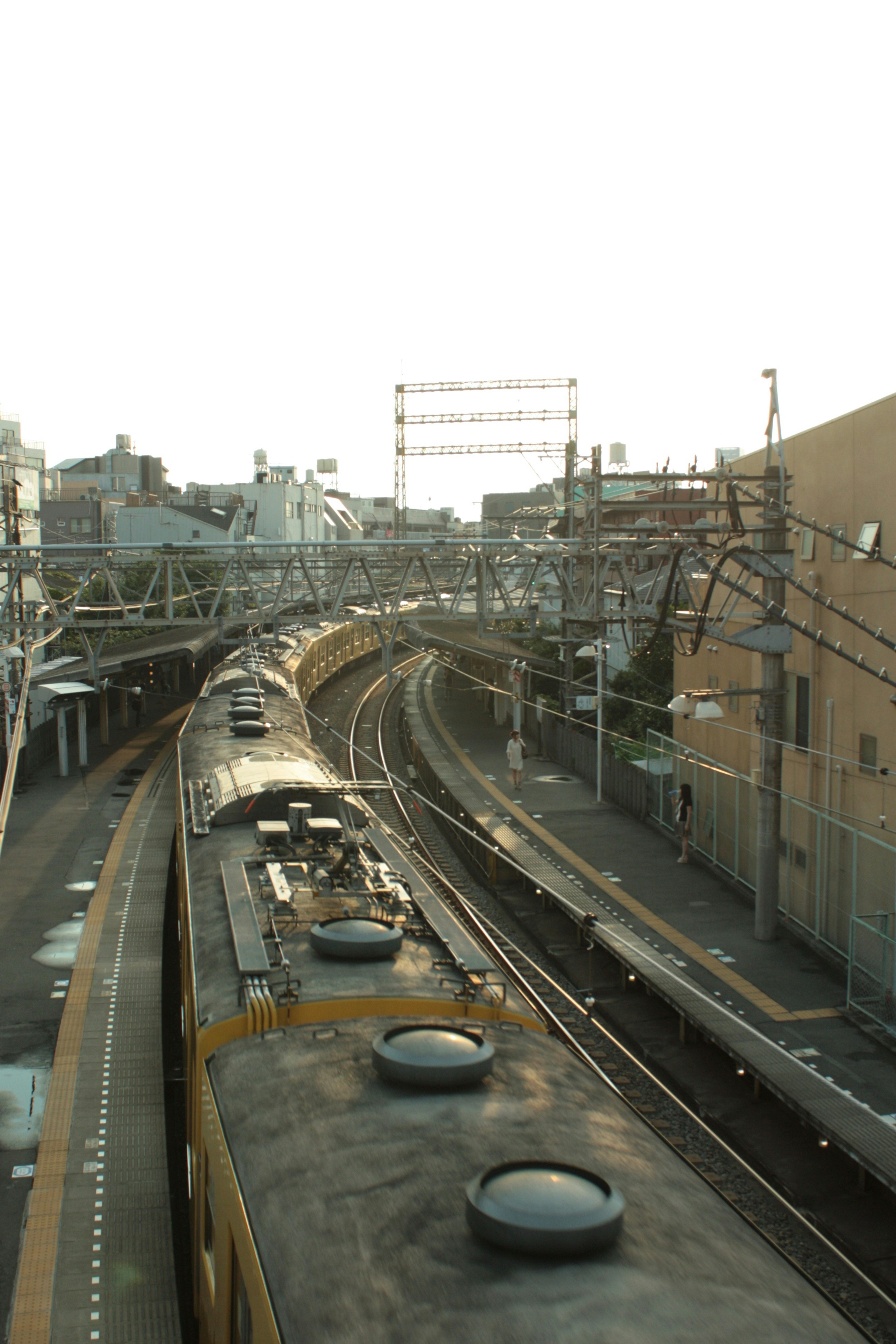 Curved railway track with a train in the background