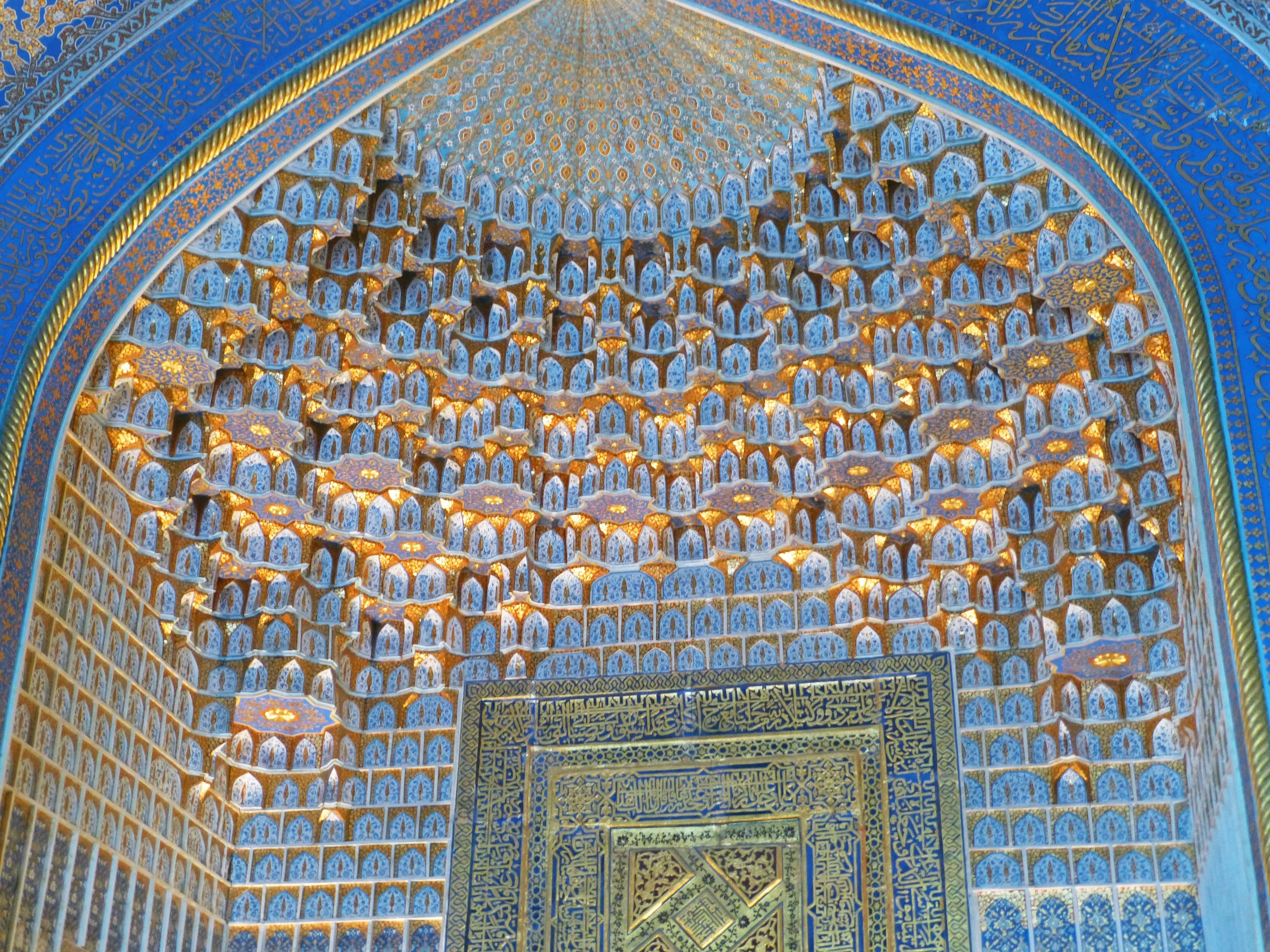 Archway with intricate blue ceiling and ornate lighting fixtures