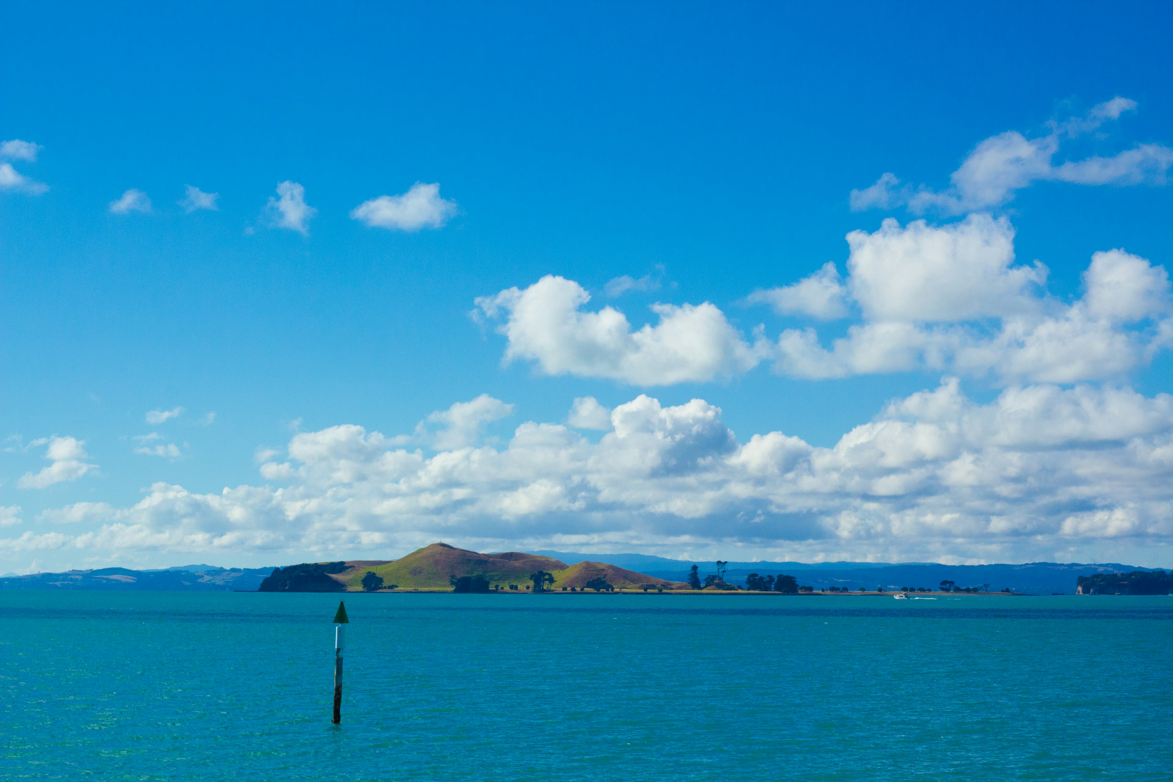 Malersicher Blick auf das blaue Meer mit Inseln unter einem bewölkten Himmel