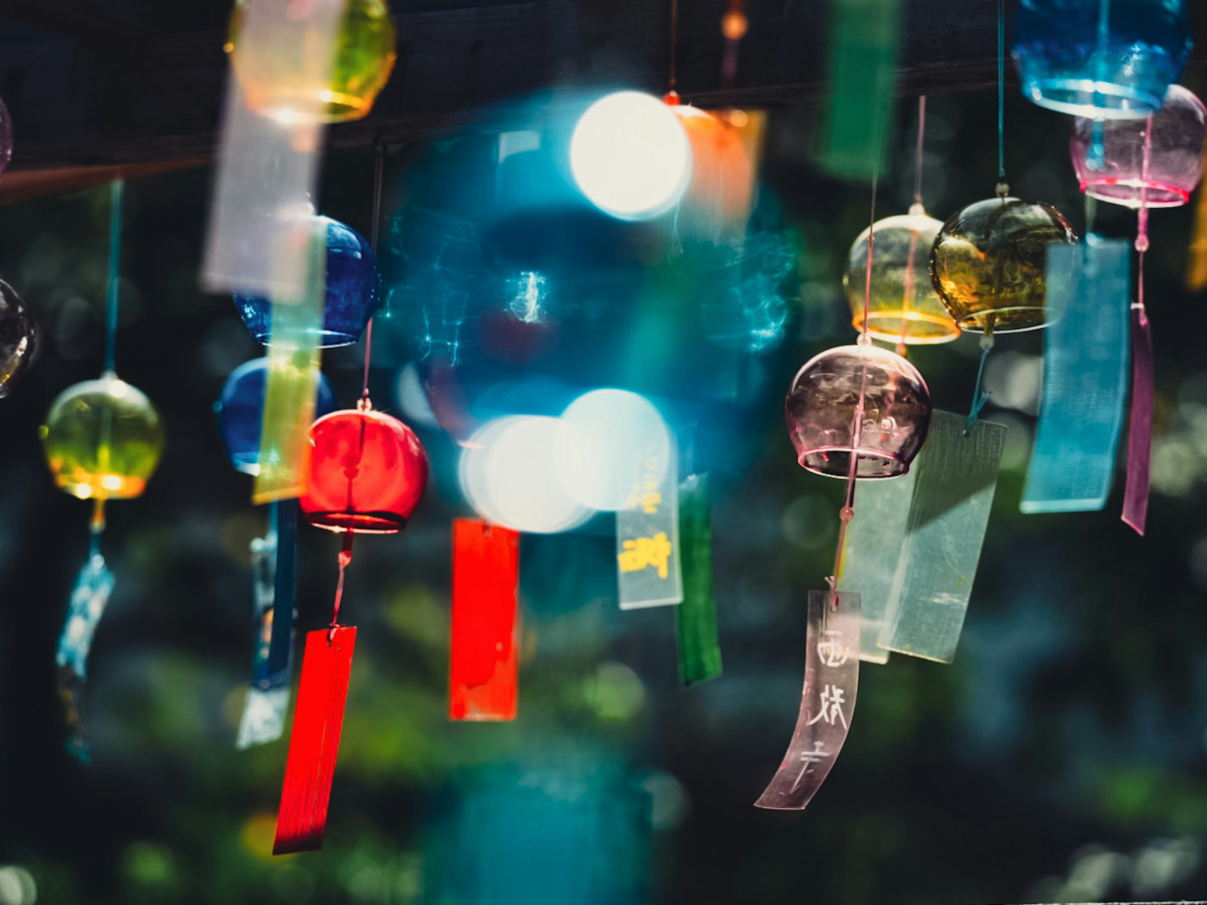 Colorful wind chimes hanging in a beautiful scene