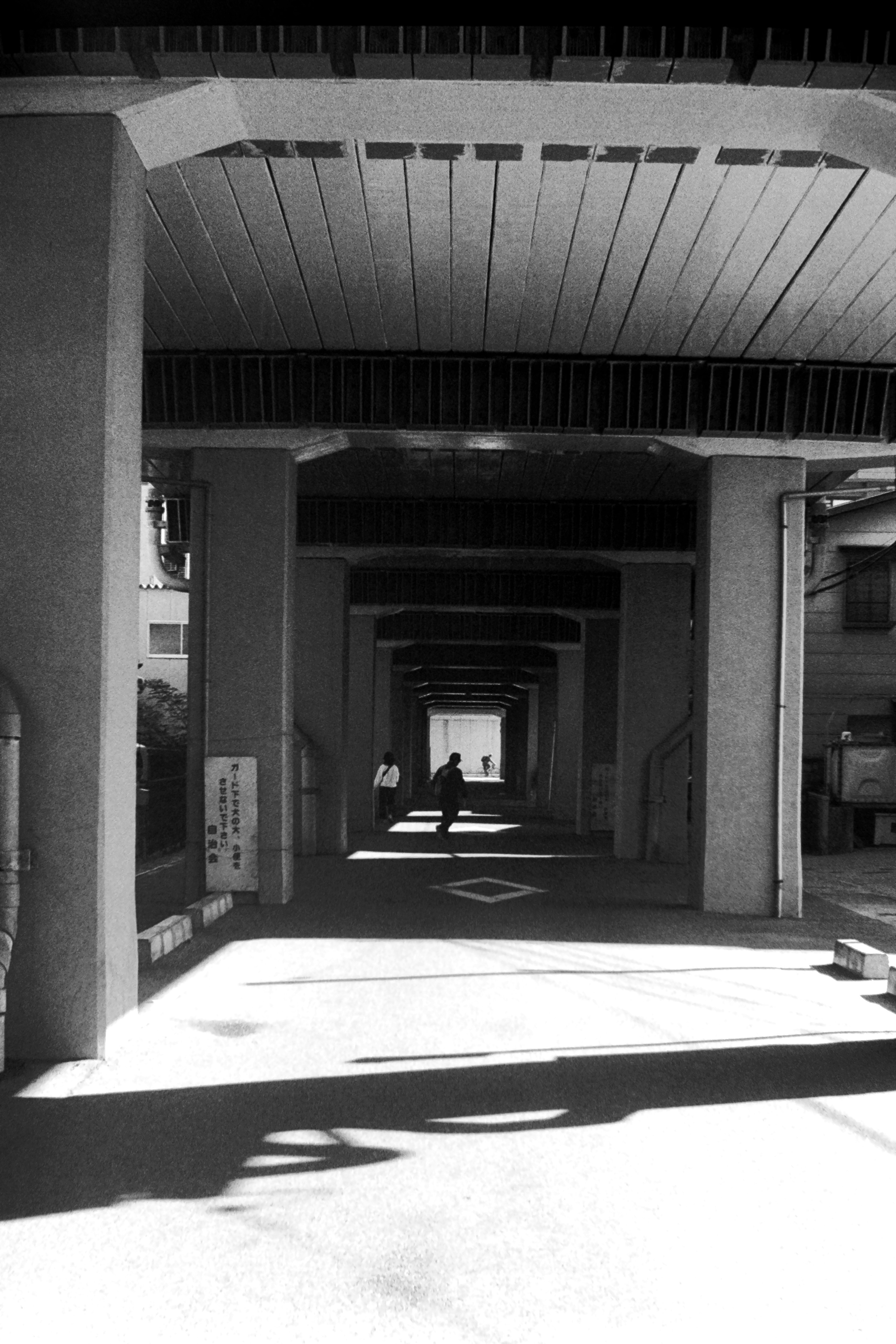 Black and white arched corridor with a silhouette