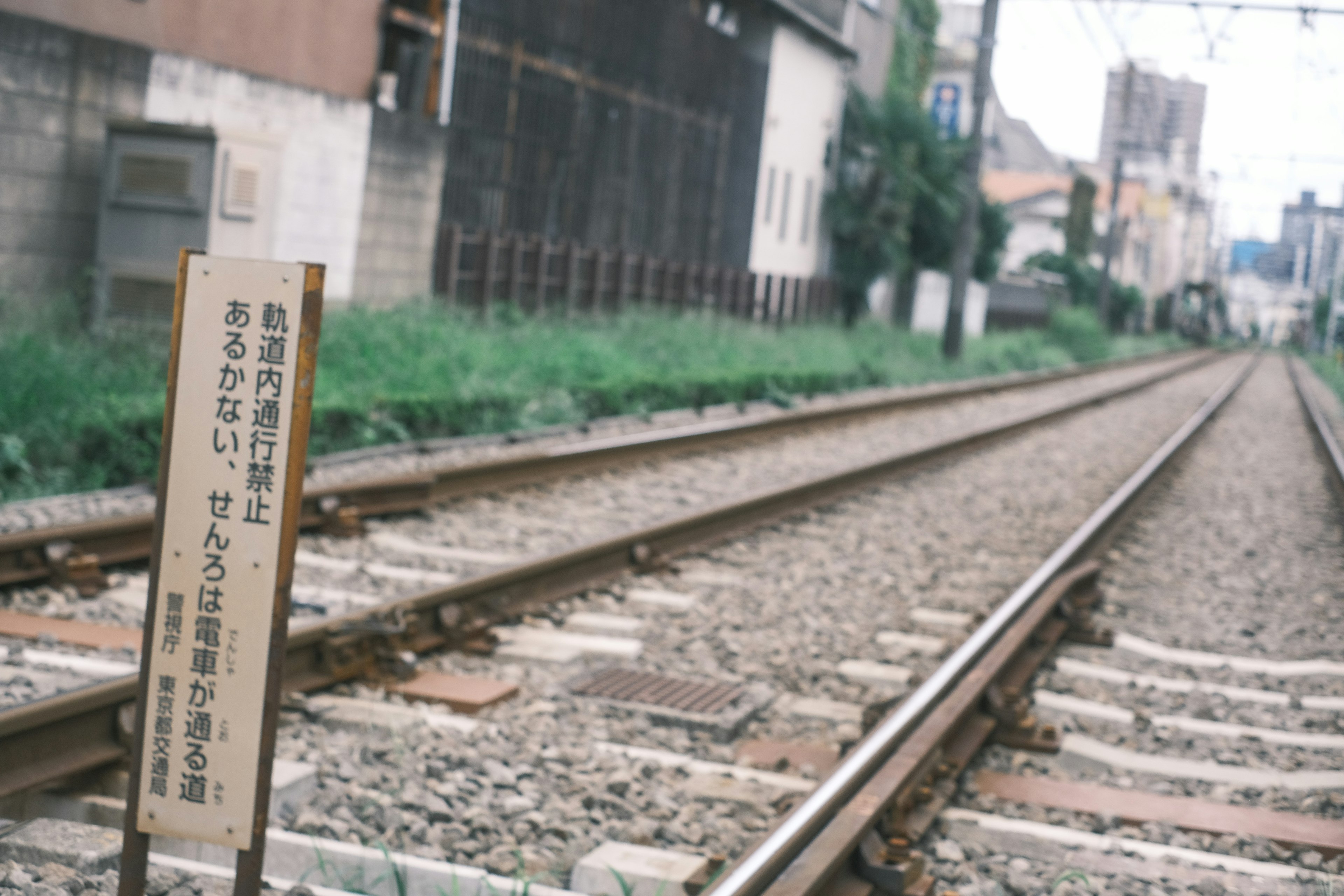 View of railway tracks with a warning sign