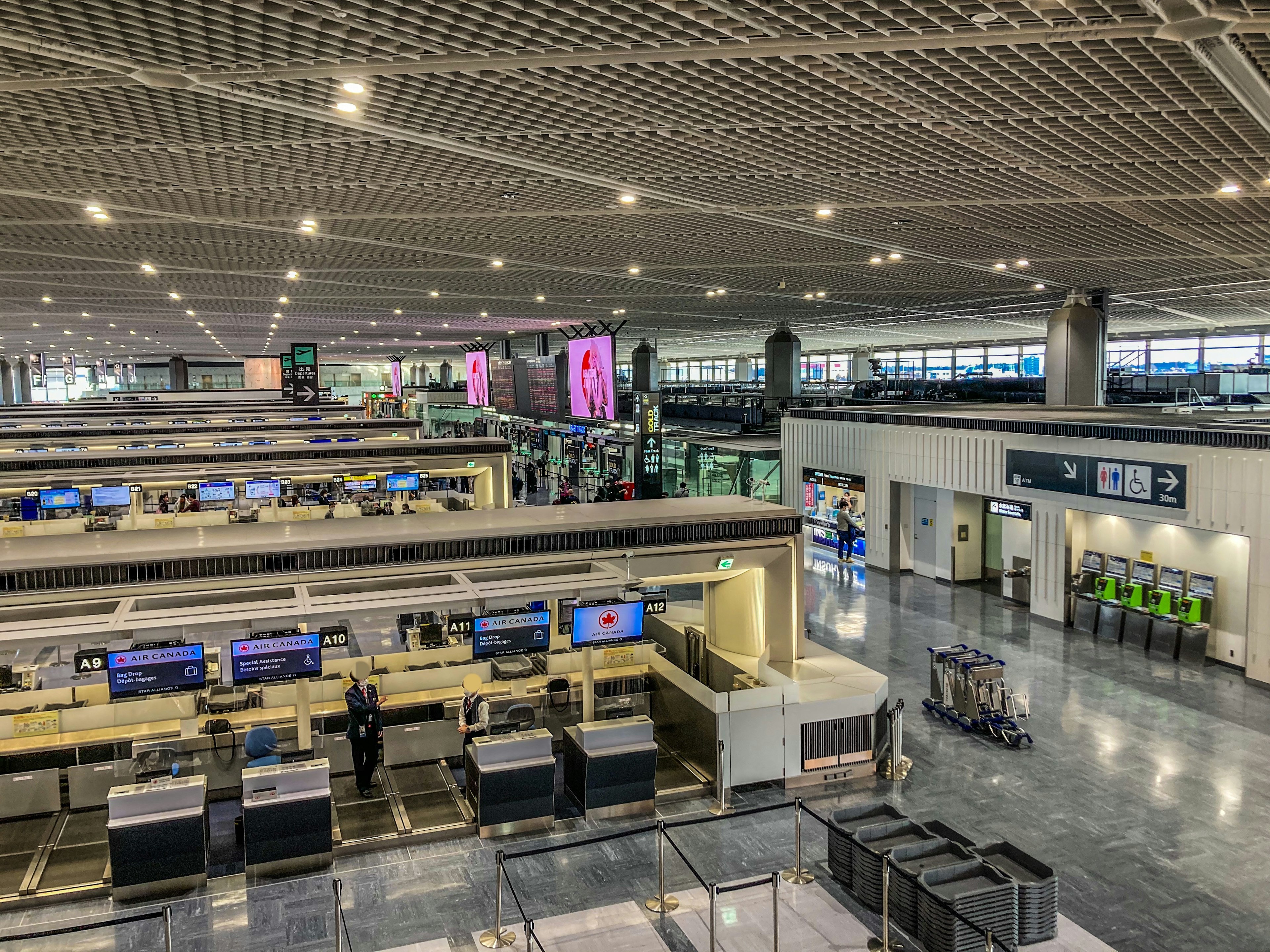 Modern airport check-in area with bright lighting