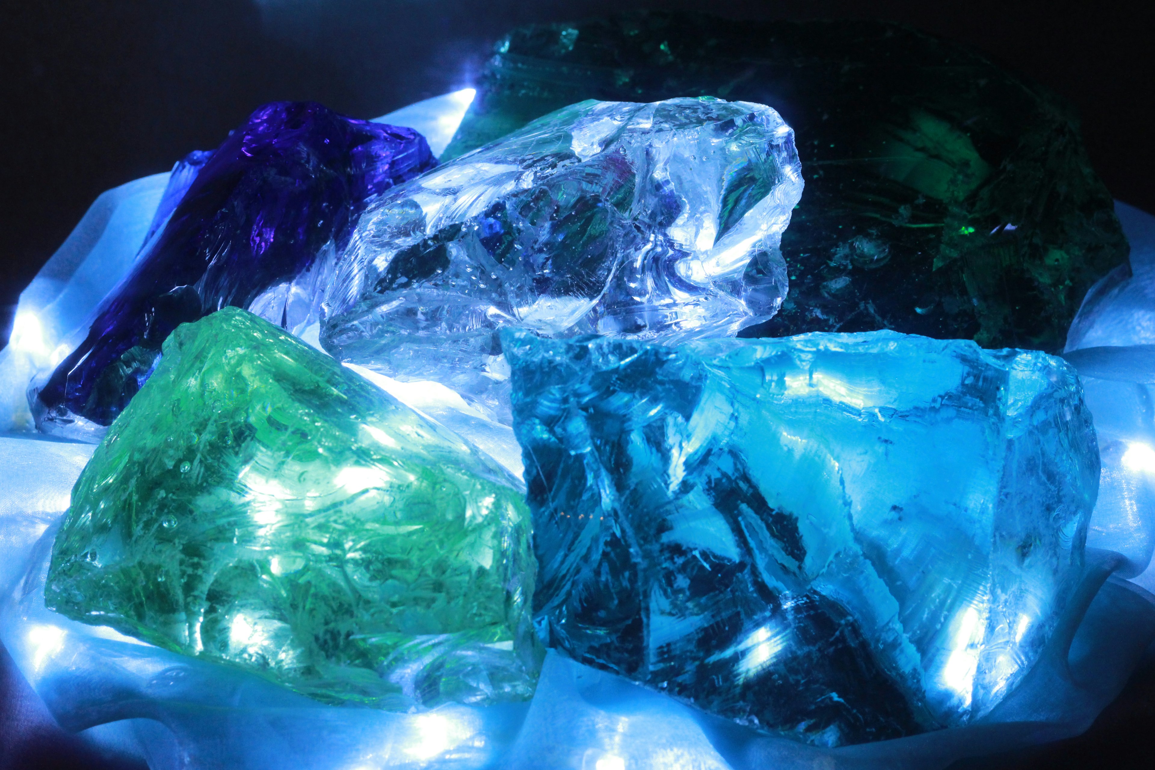 Various colored large crystals illuminated by blue light