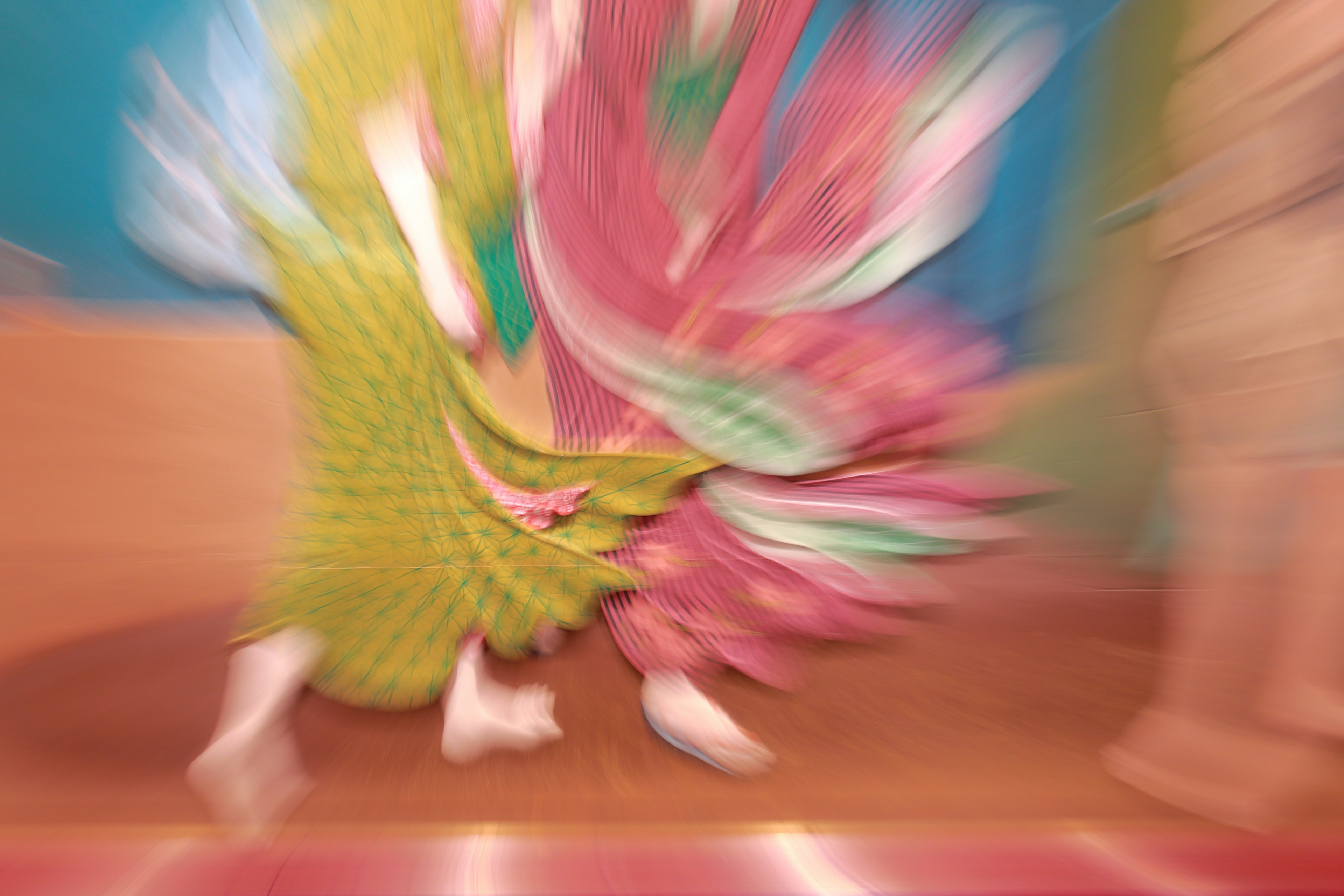 Dancers in vibrant costumes captured in motion