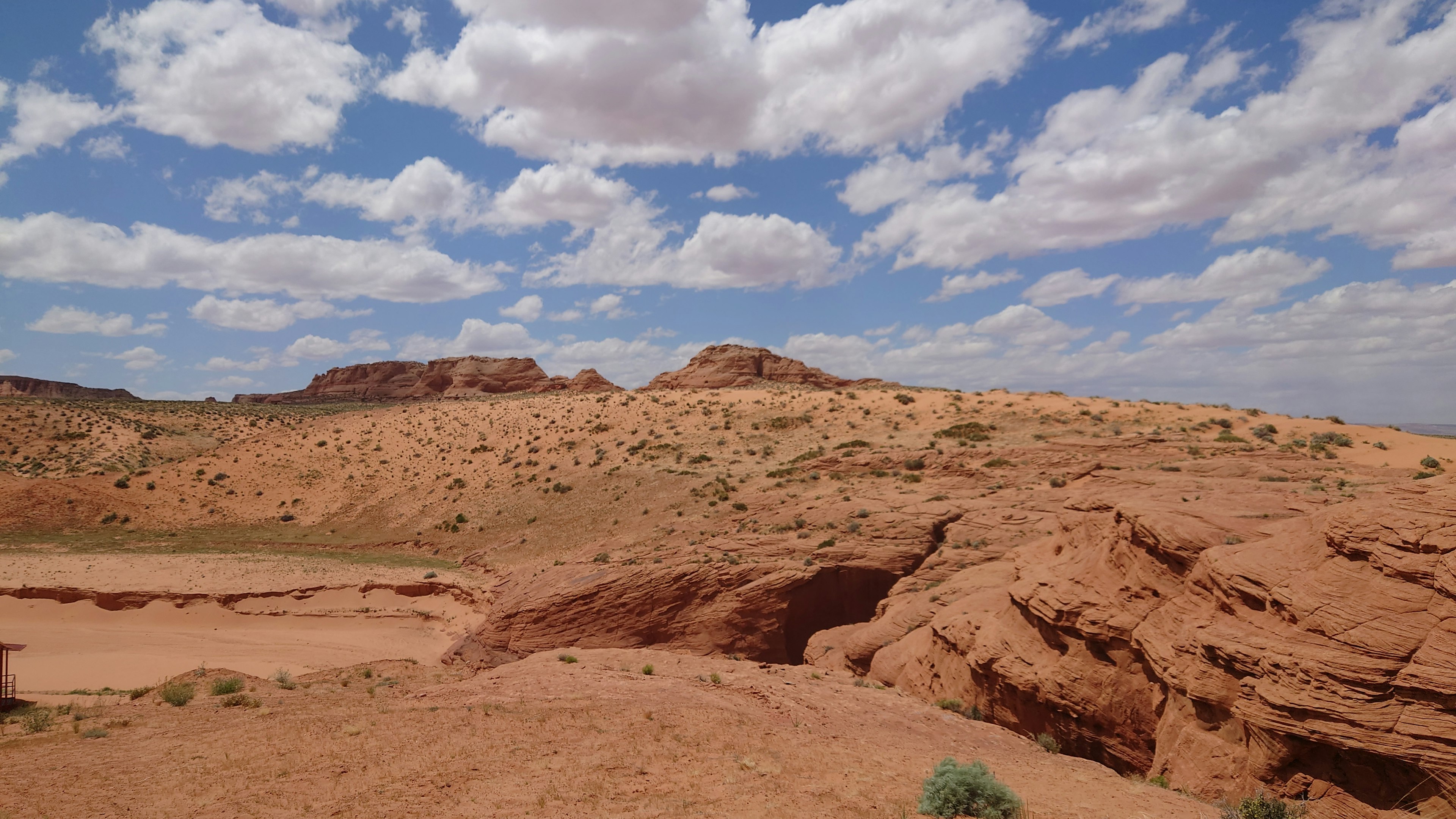 Desert landscape featuring red rock formations and expansive sky