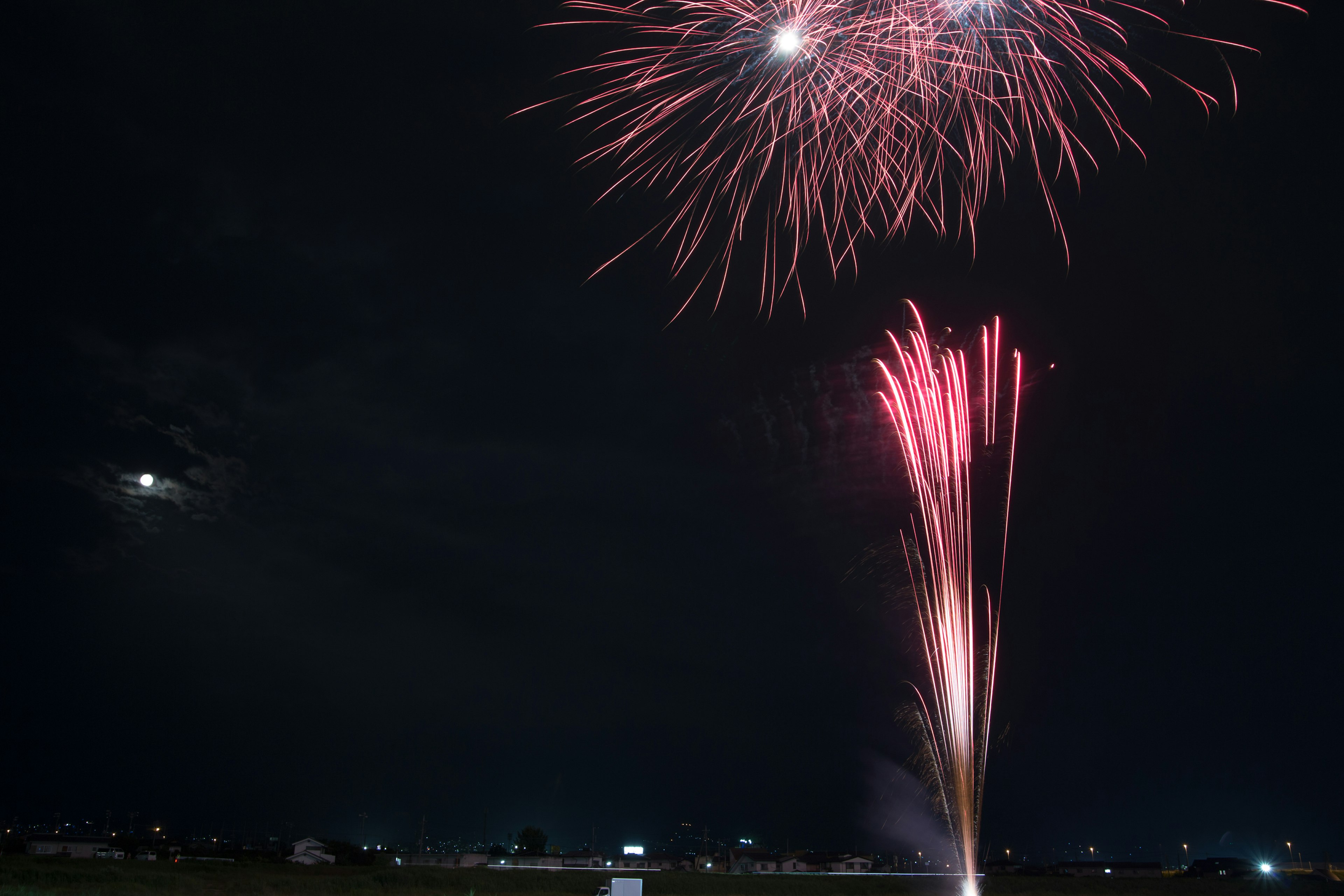 Beautiful display of fireworks in the night sky with red sparks