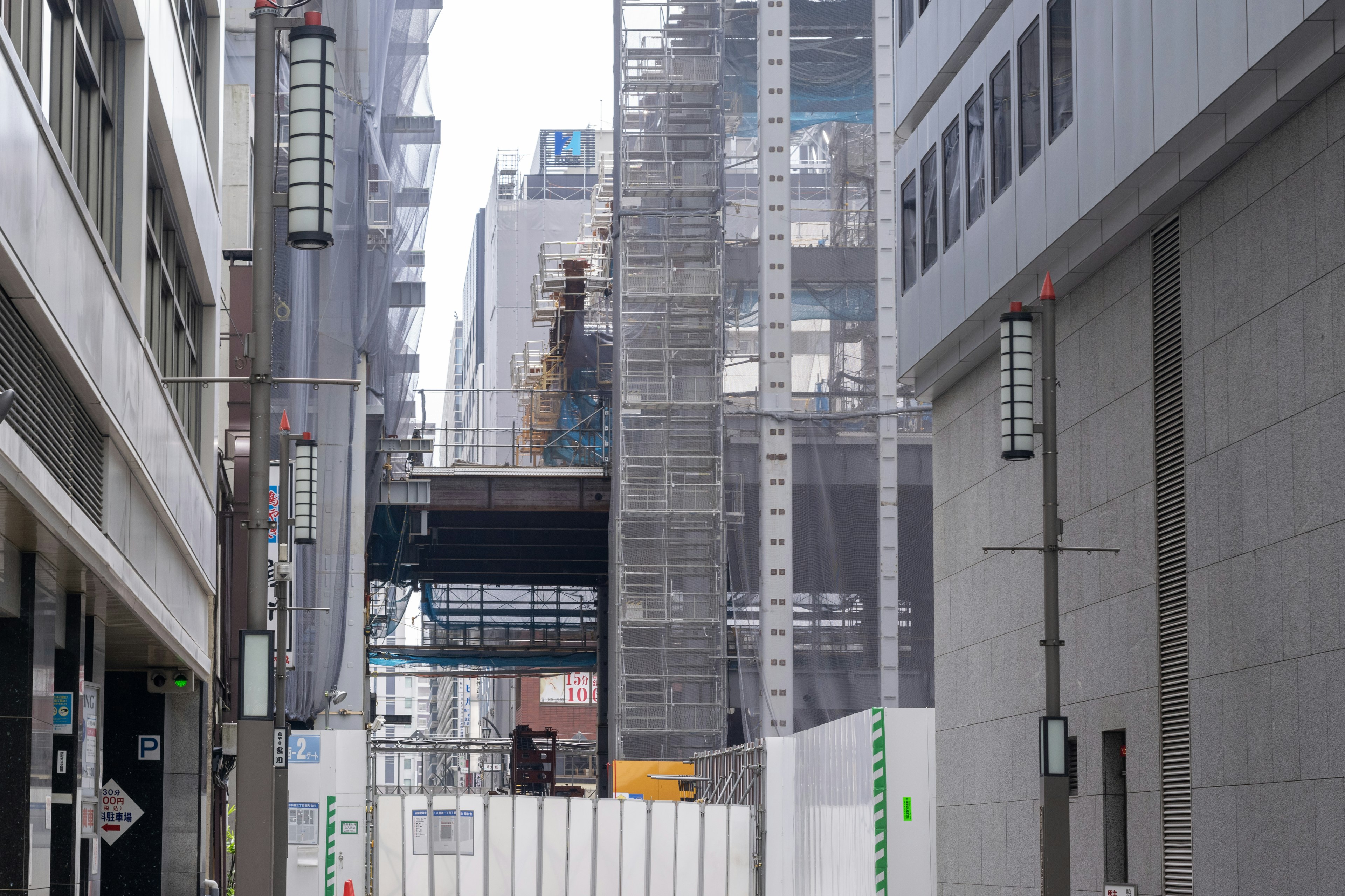 Narrow street view with buildings and construction site