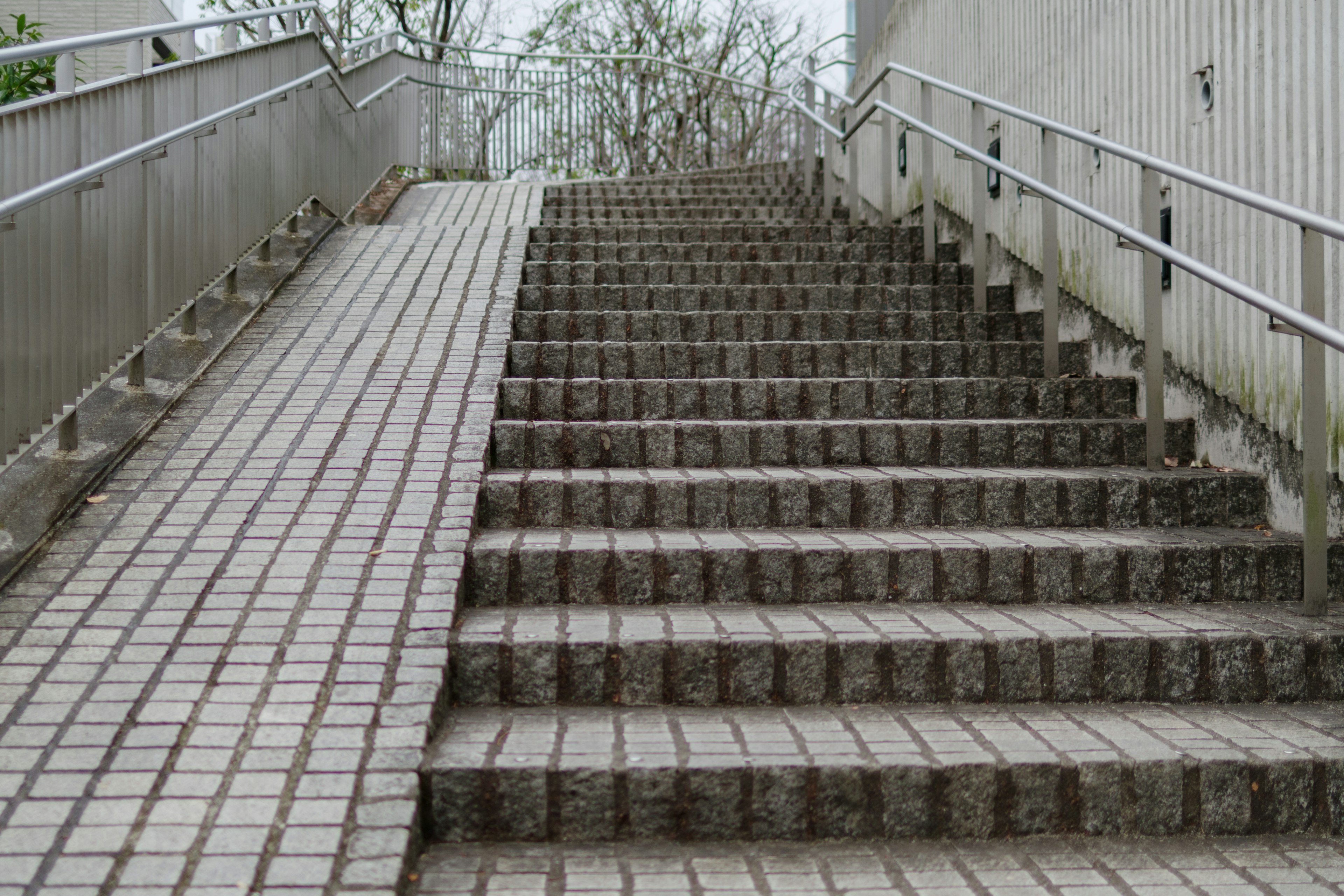 Outdoor view featuring a staircase and a ramp