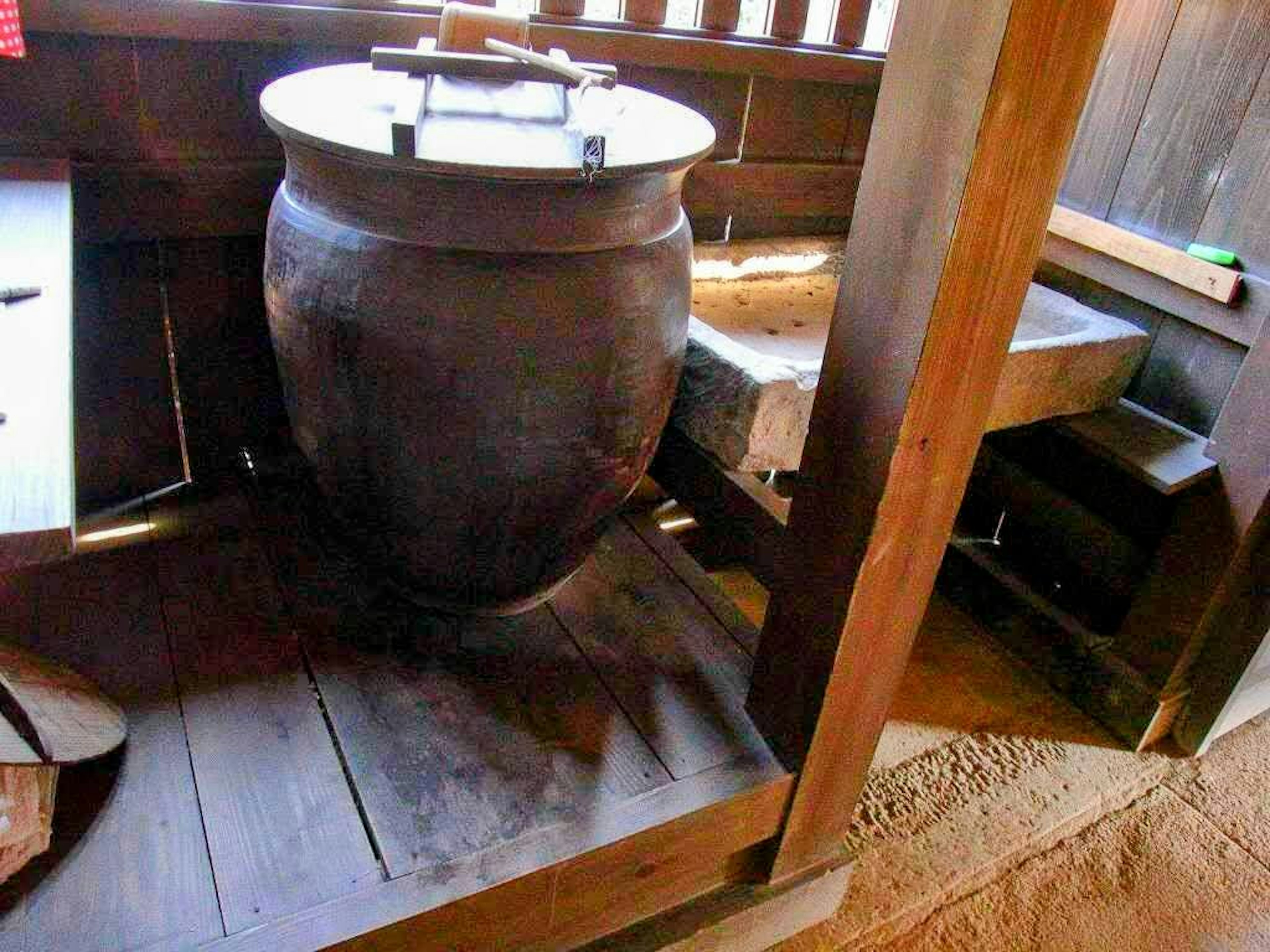 Grand pot en céramique dans un intérieur en bois traditionnel avec une table en bois