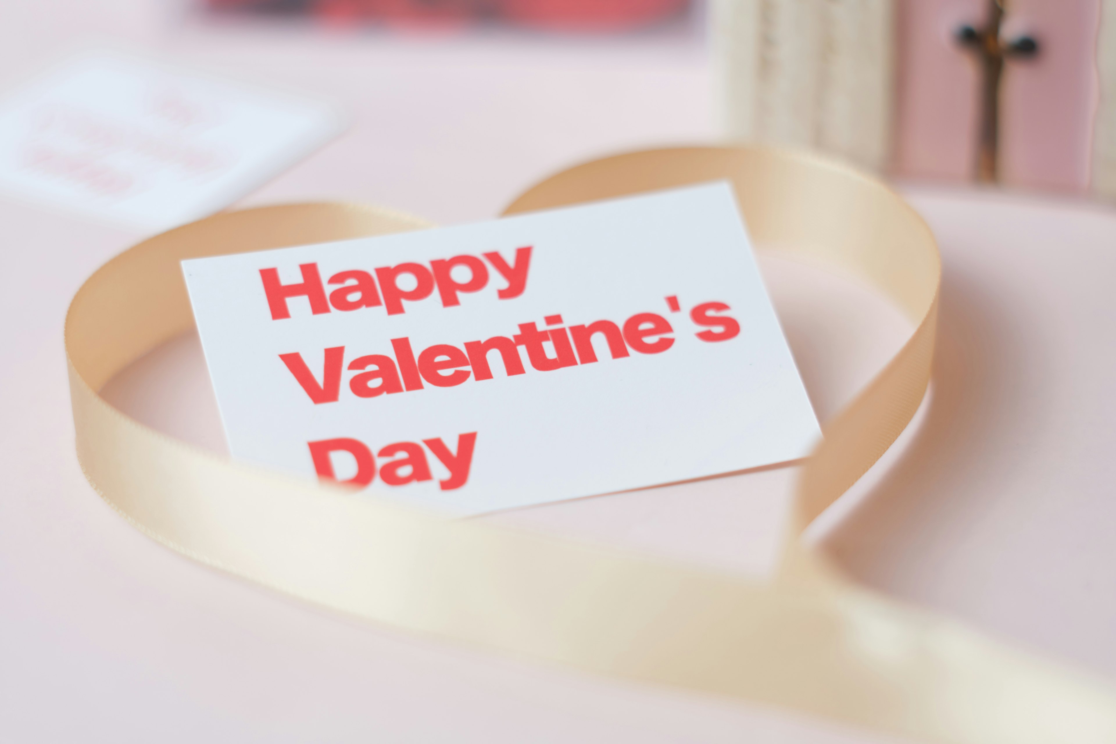 Valentine's Day greeting card with a ribbon in heart shape