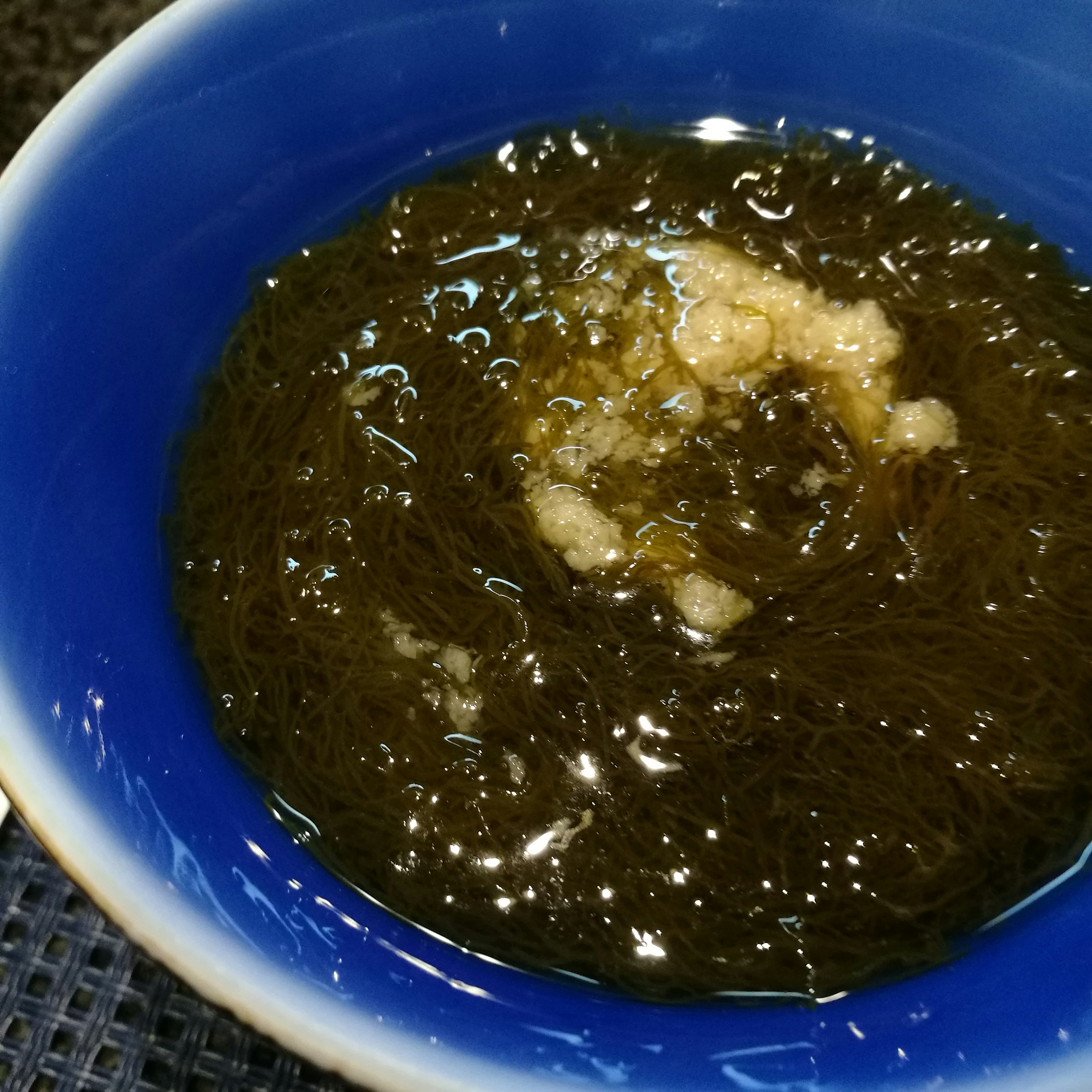 Seaweed soup with ginger in a blue bowl