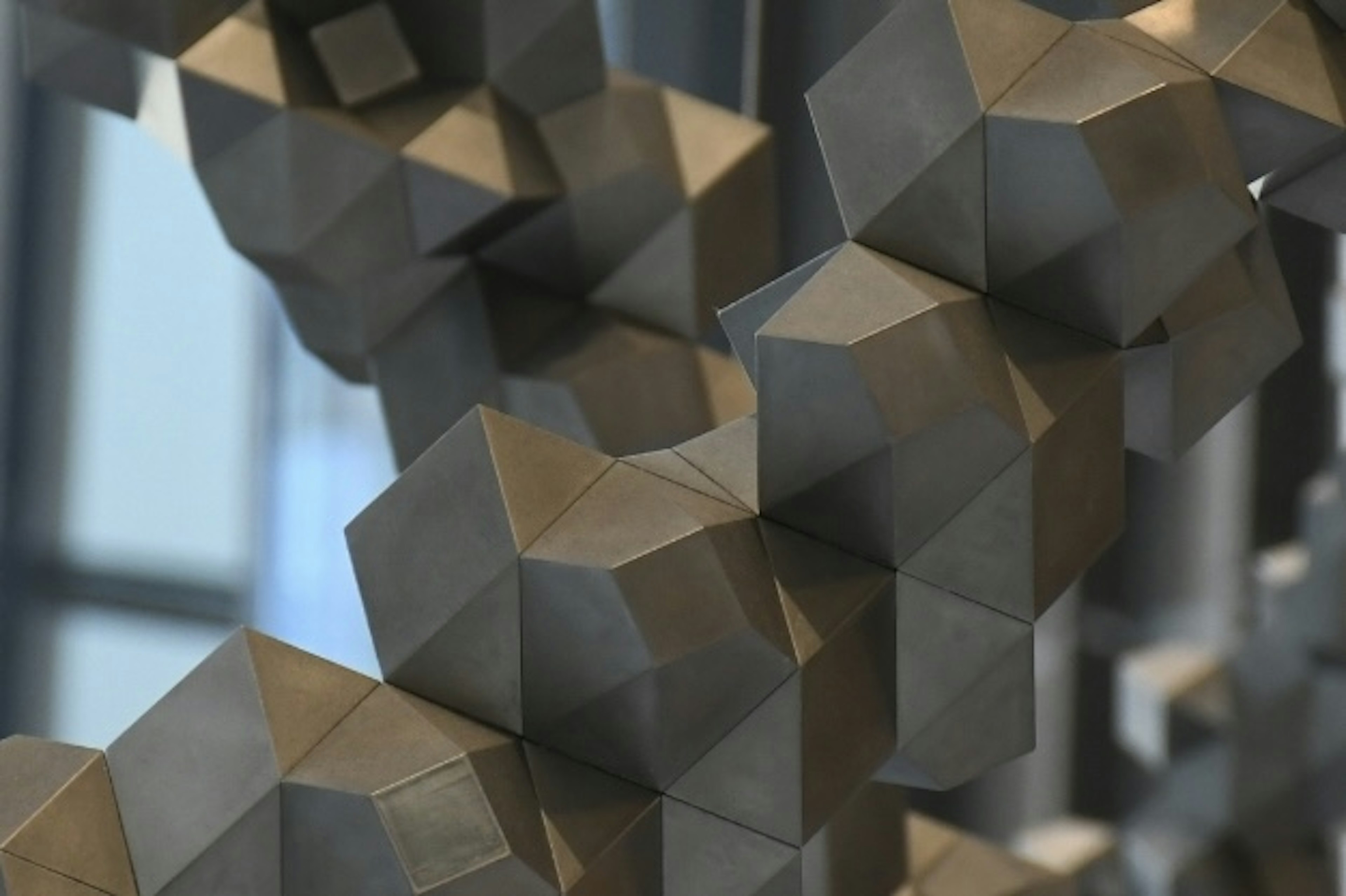 Close-up image of a geometric sculpture featuring interlocking hexagonal shapes