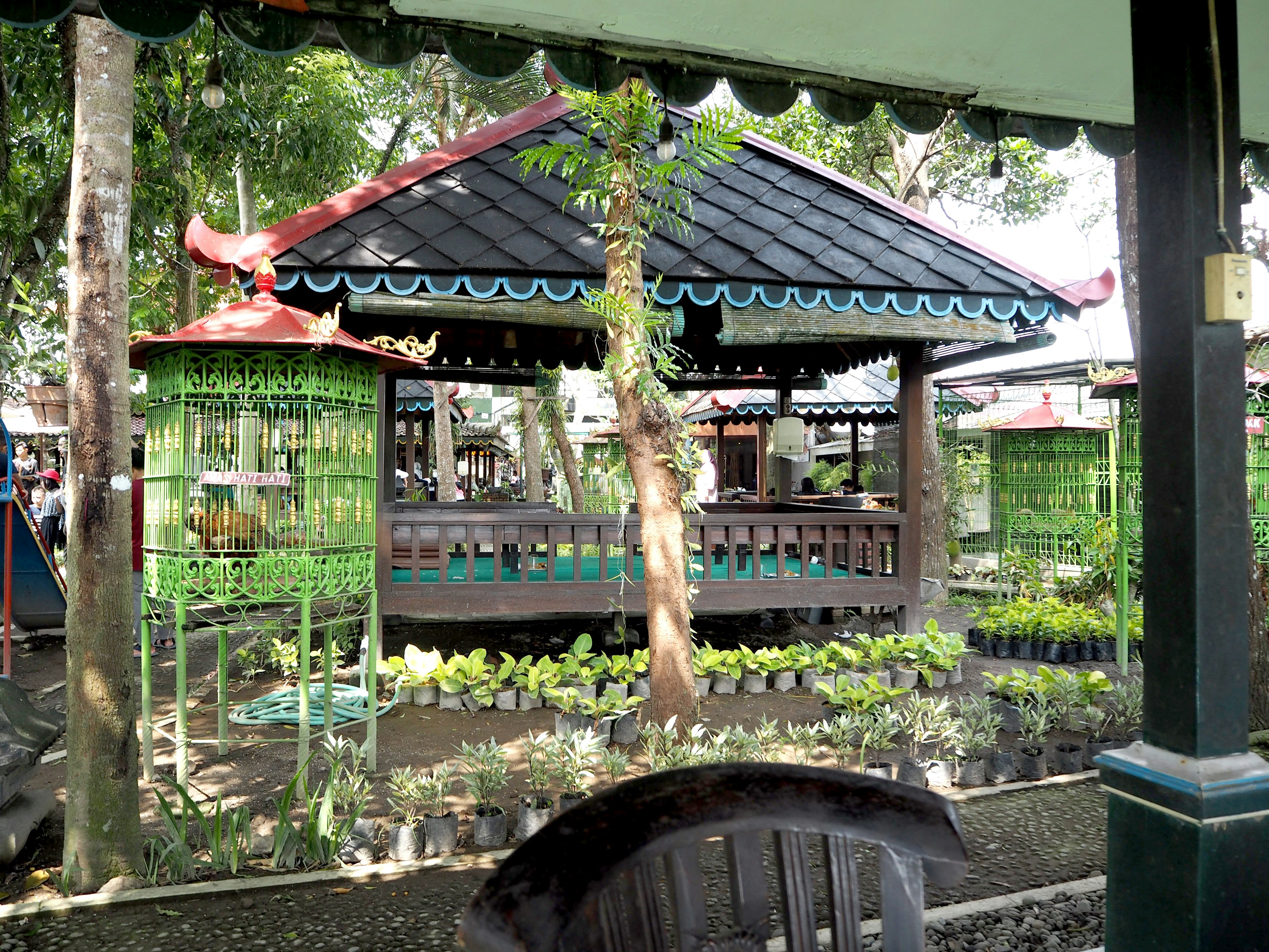 Traditional Balinese pavilion surrounded by green plants