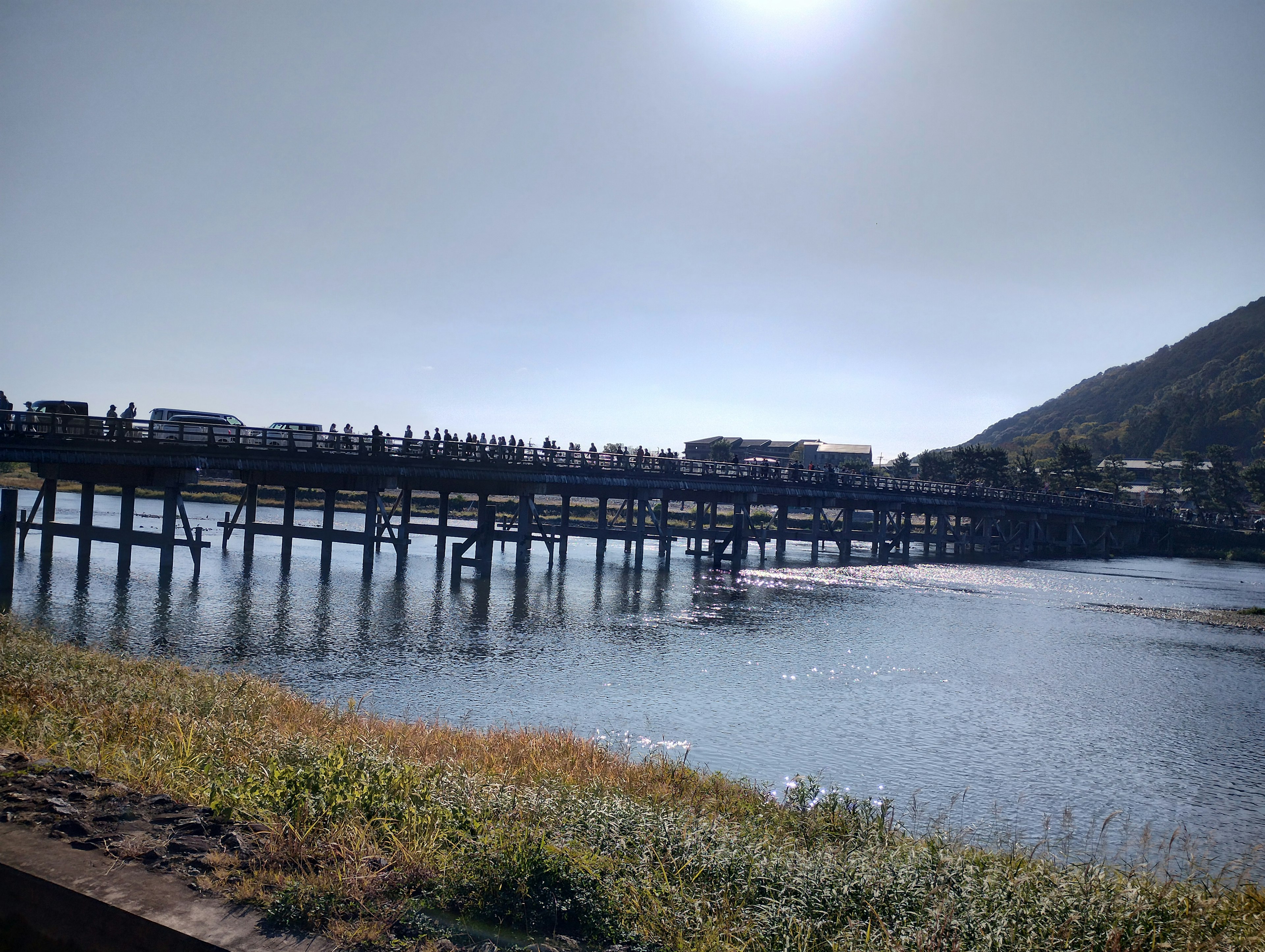 Scenic view of a pier reflecting on calm water with a mountain backdrop