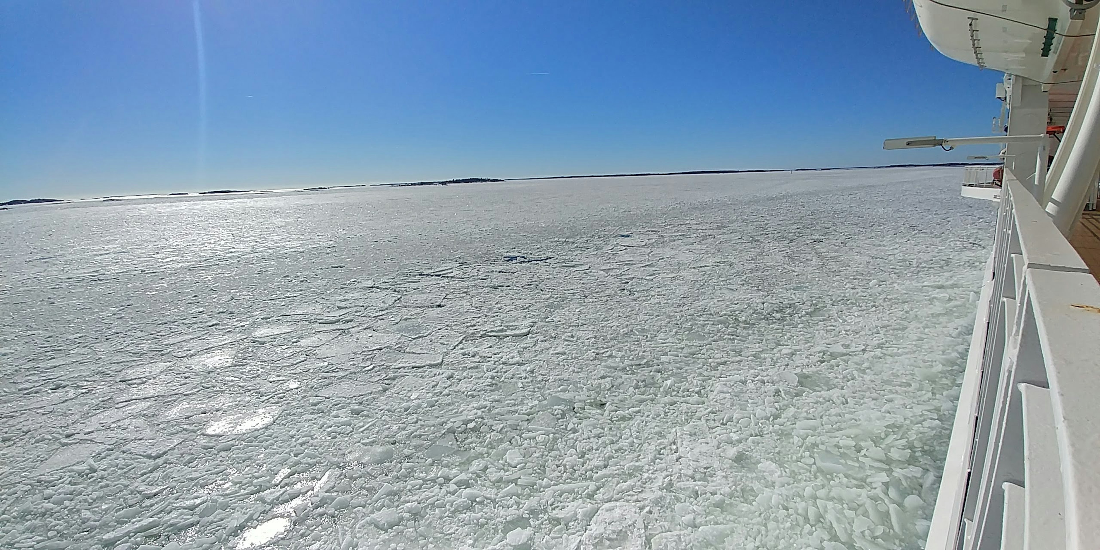 A panoramic view of a frozen sea under a clear blue sky