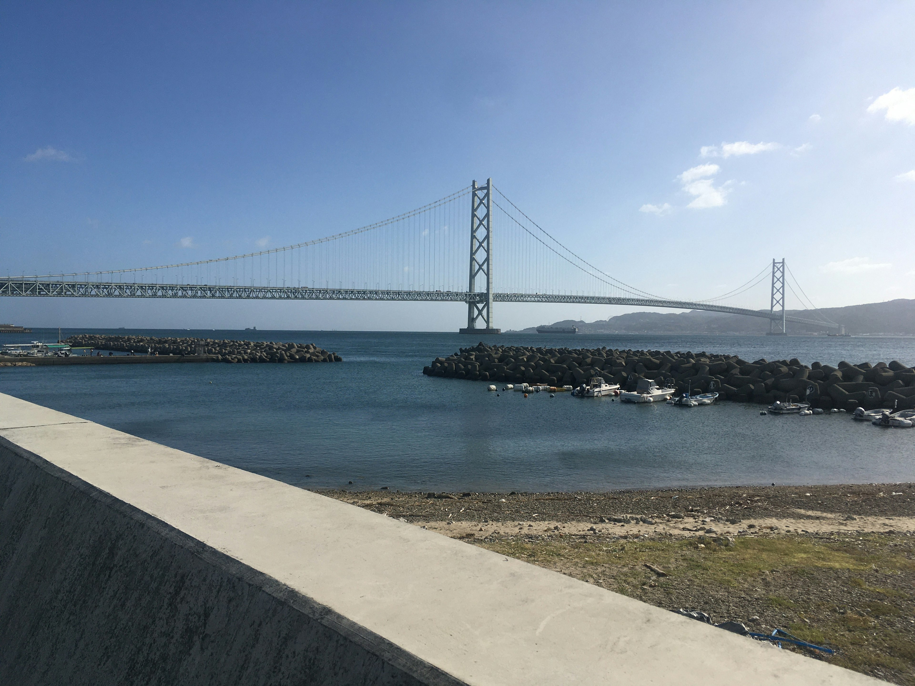 Scenic view of the Akashi Kaikyō Bridge over a calm sea