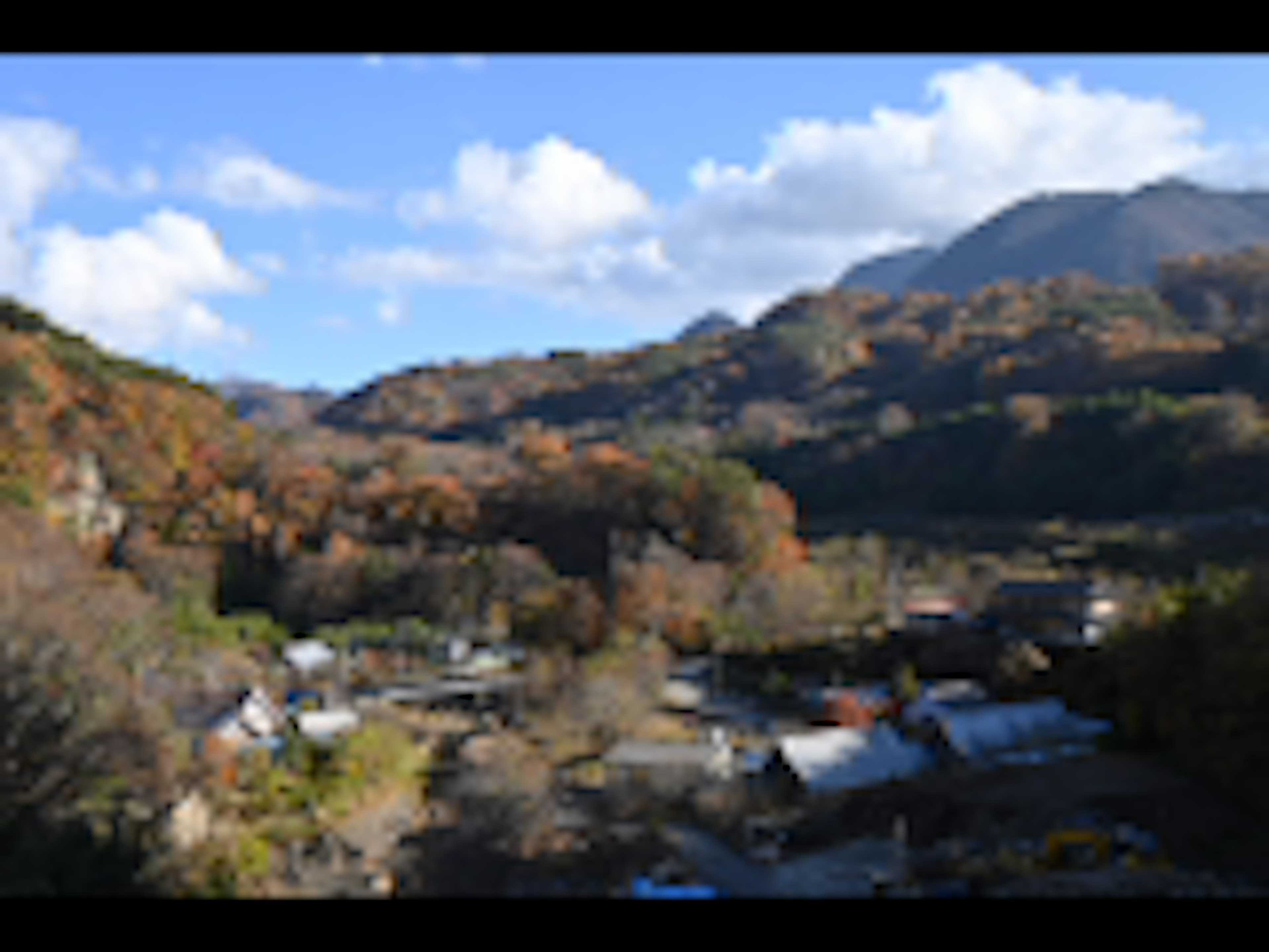 Scenic view of autumn mountains and village