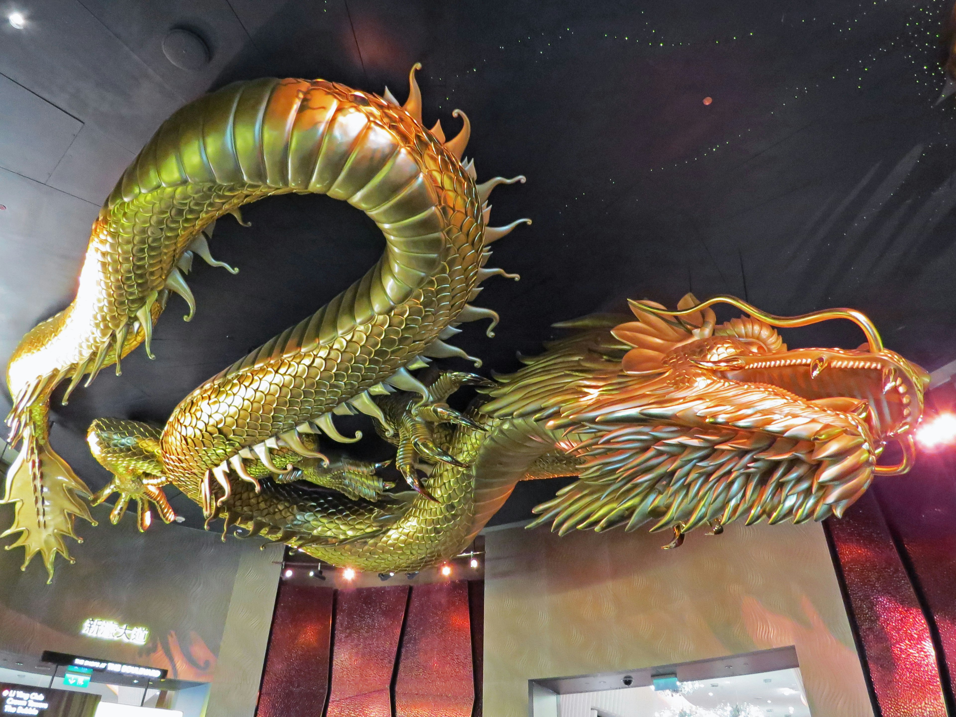 A stunning golden dragon sculpture hanging from the ceiling