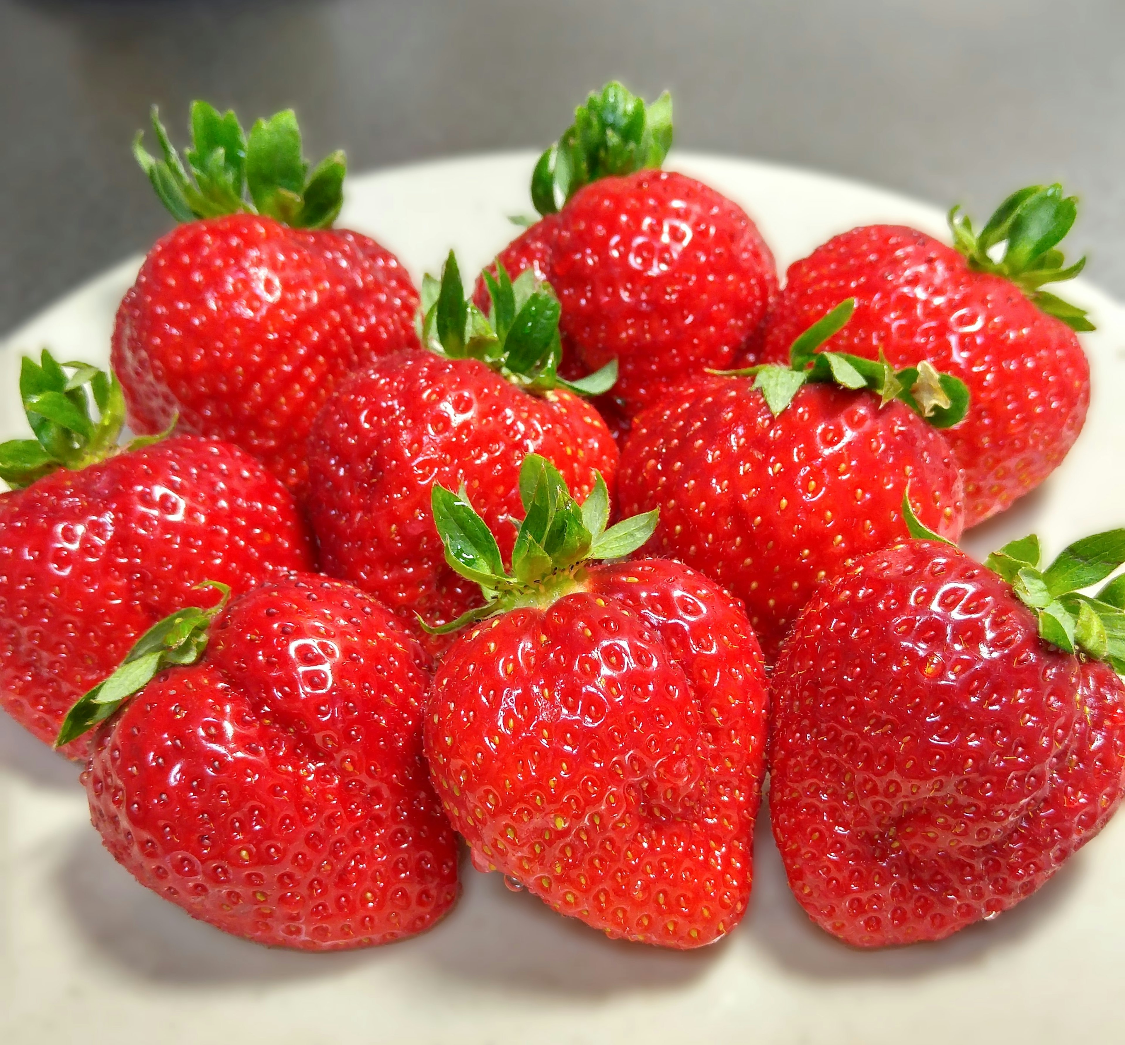 Fresh strawberries arranged on a plate