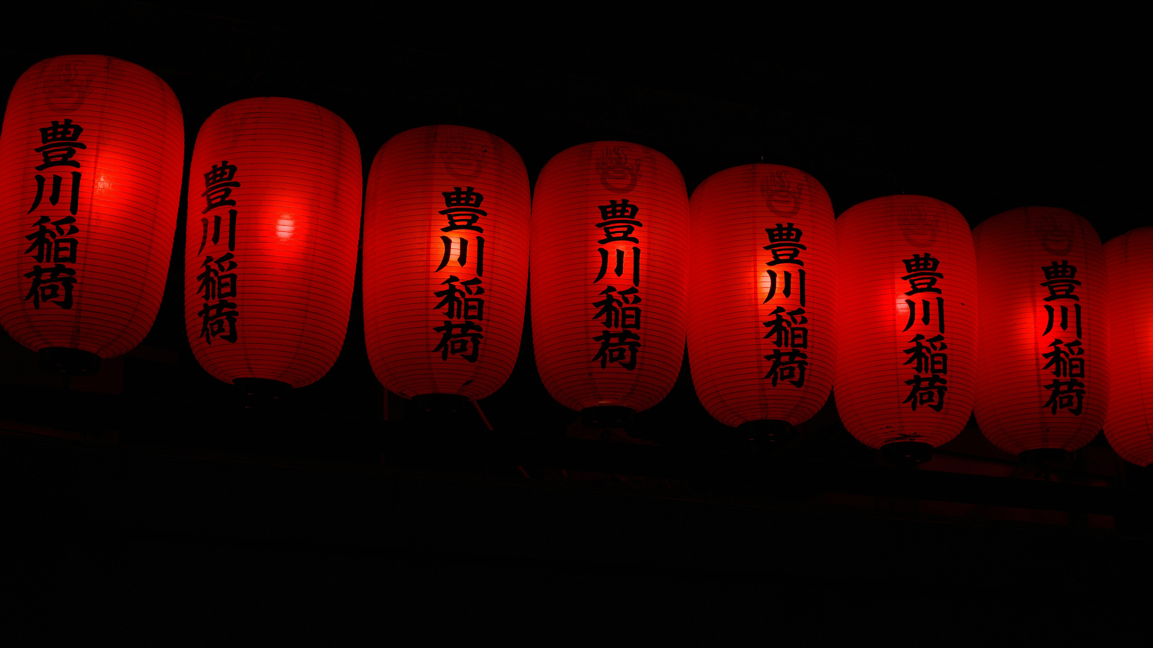 Row of red lanterns glowing in the dark