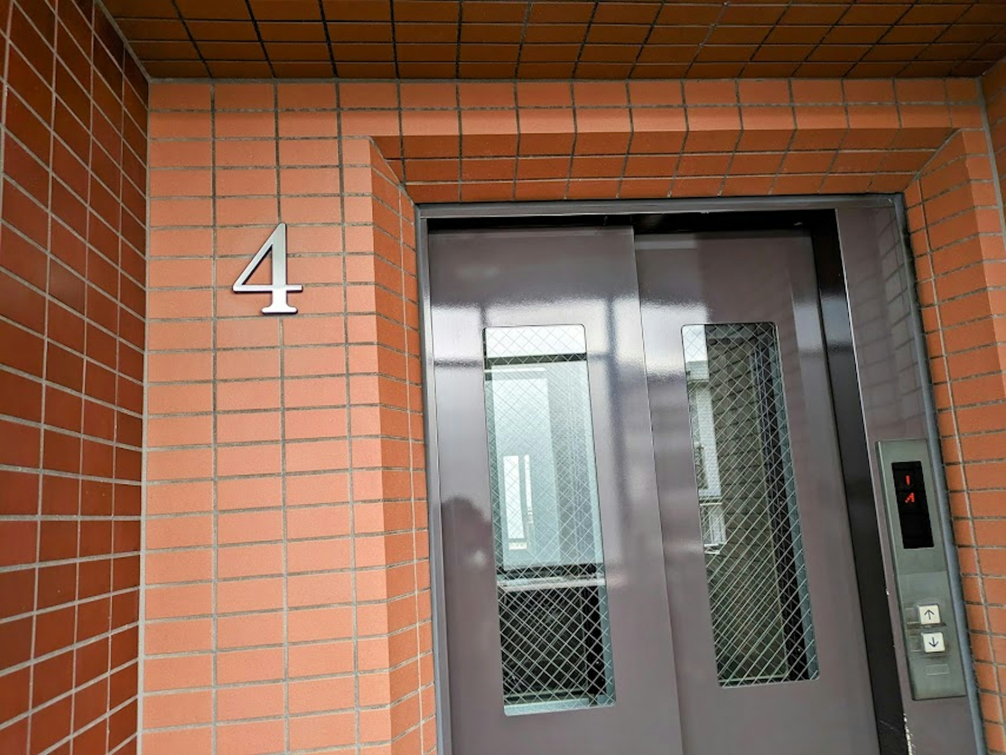 Elevator doors with number 4 on a building exterior