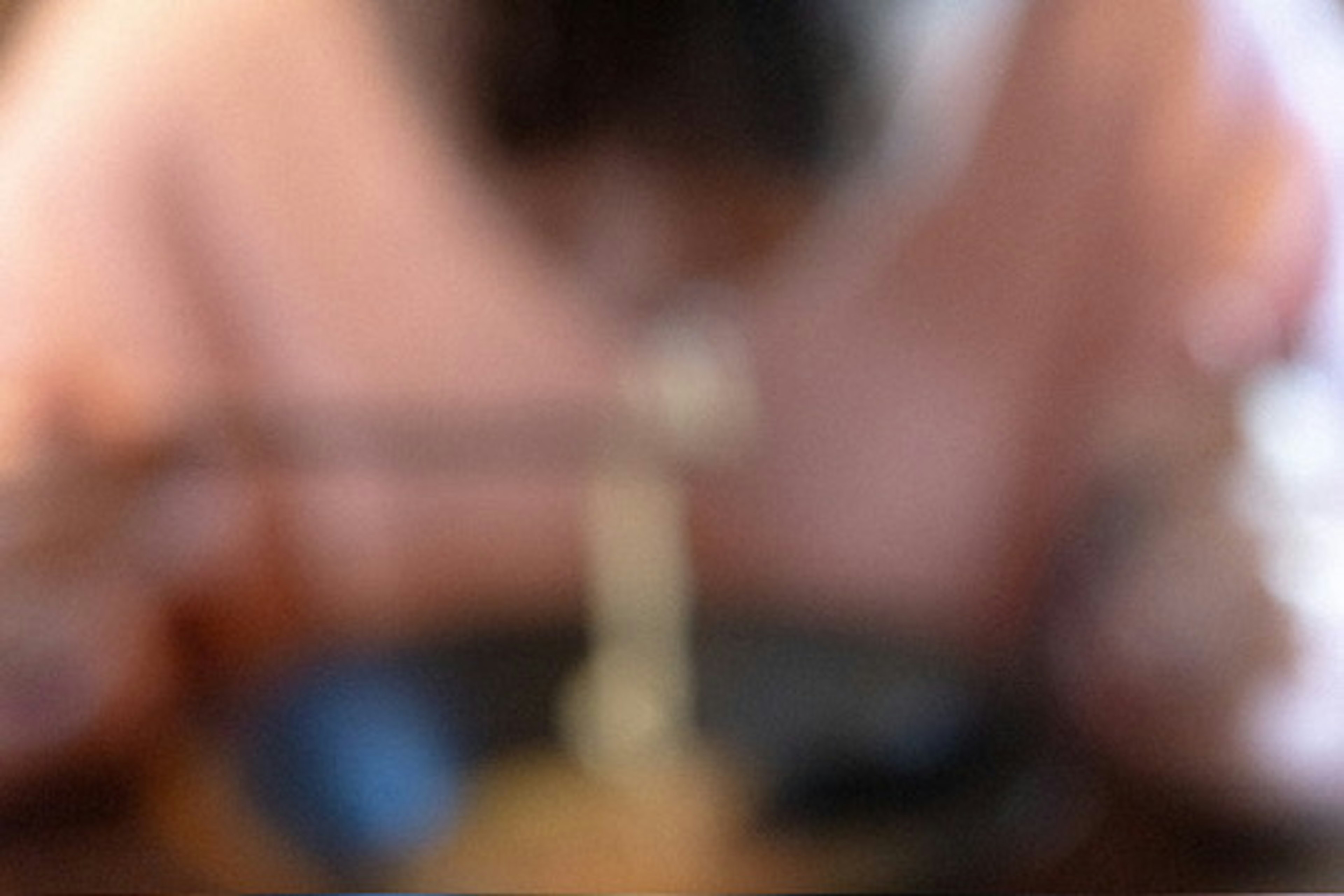 Blurred image of a person eating noodles with chopsticks