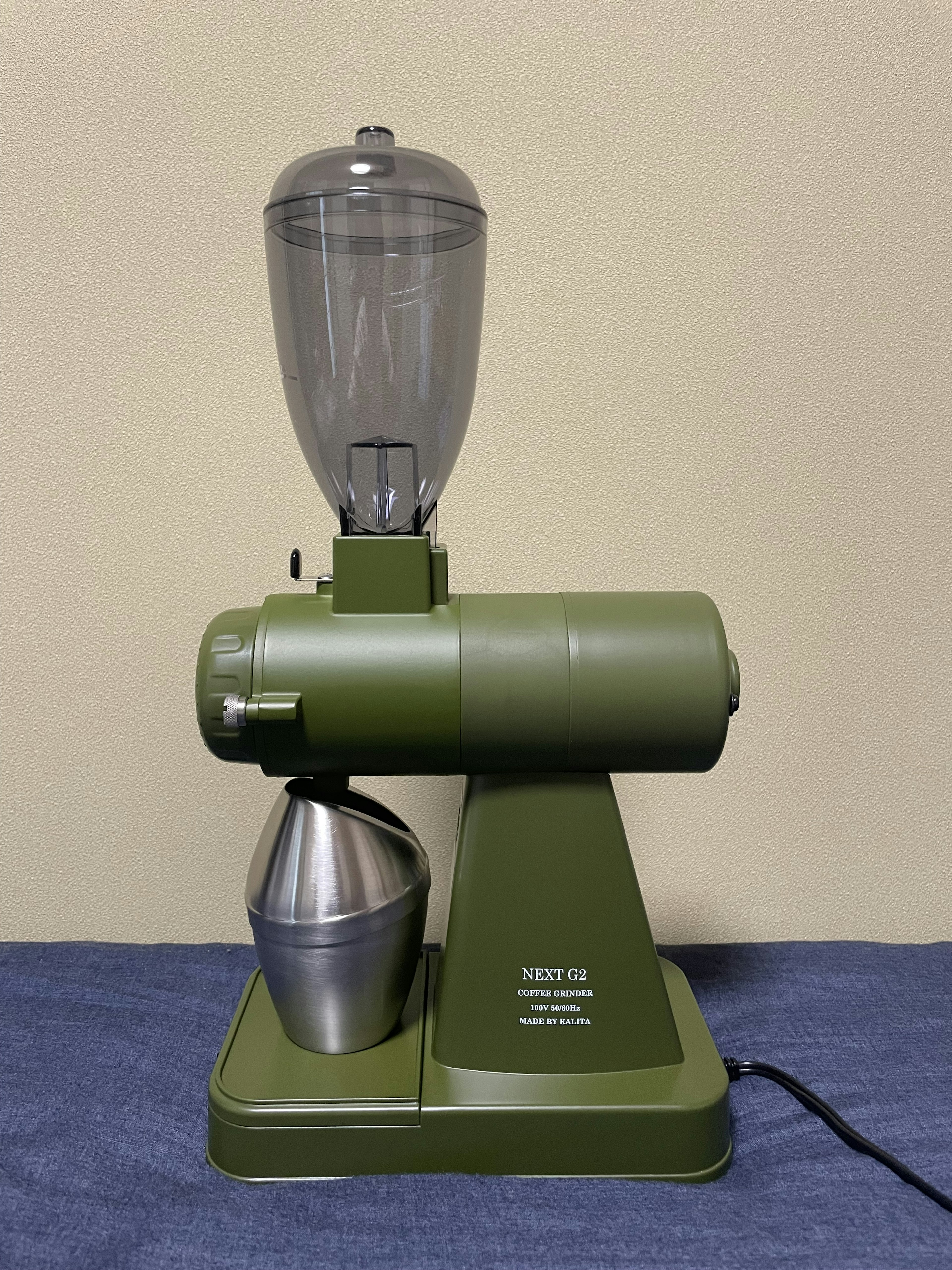 Vintage green blender with transparent container on top and metallic base