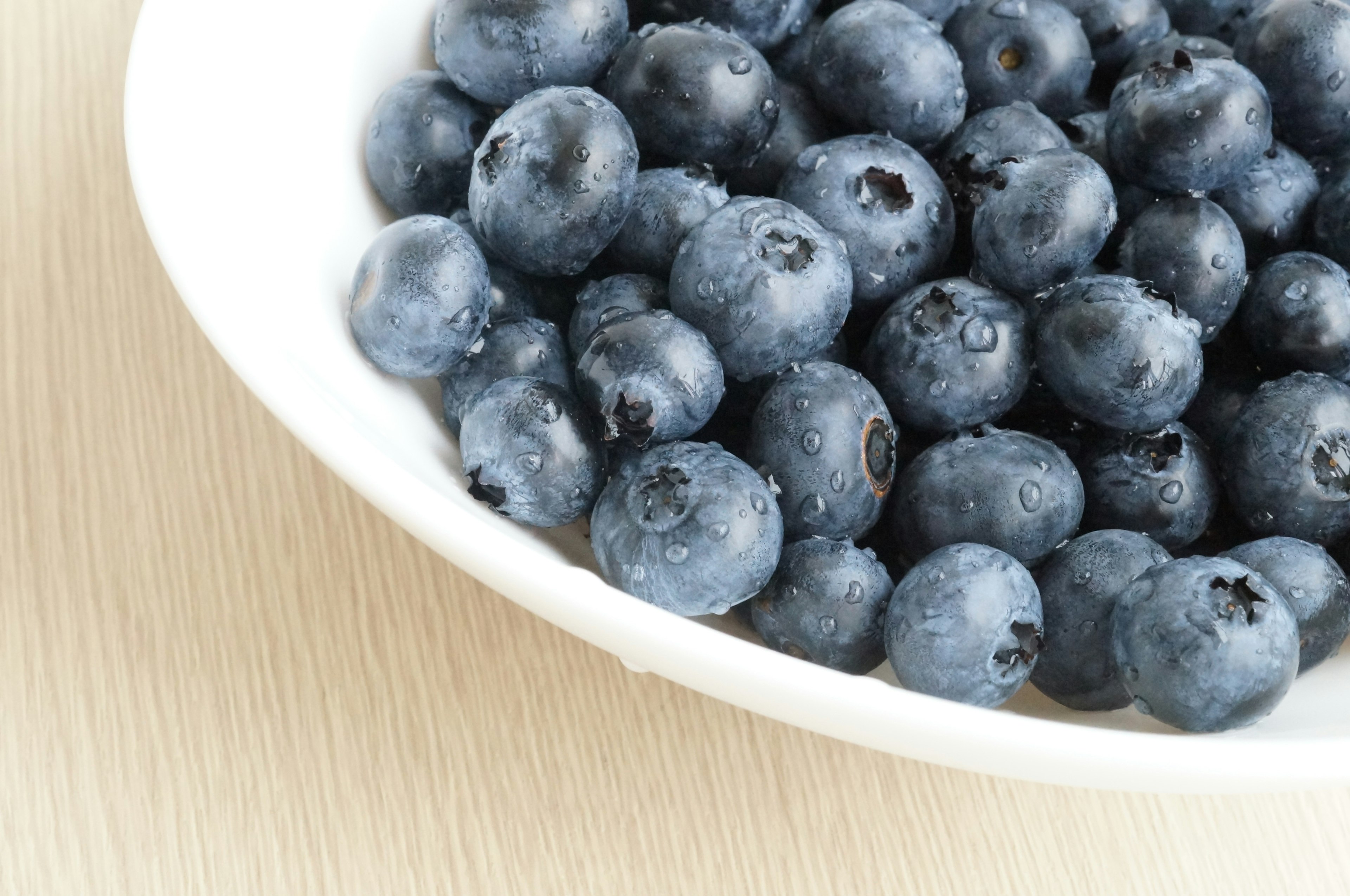 Close-up of fresh blueberries in a white bowl