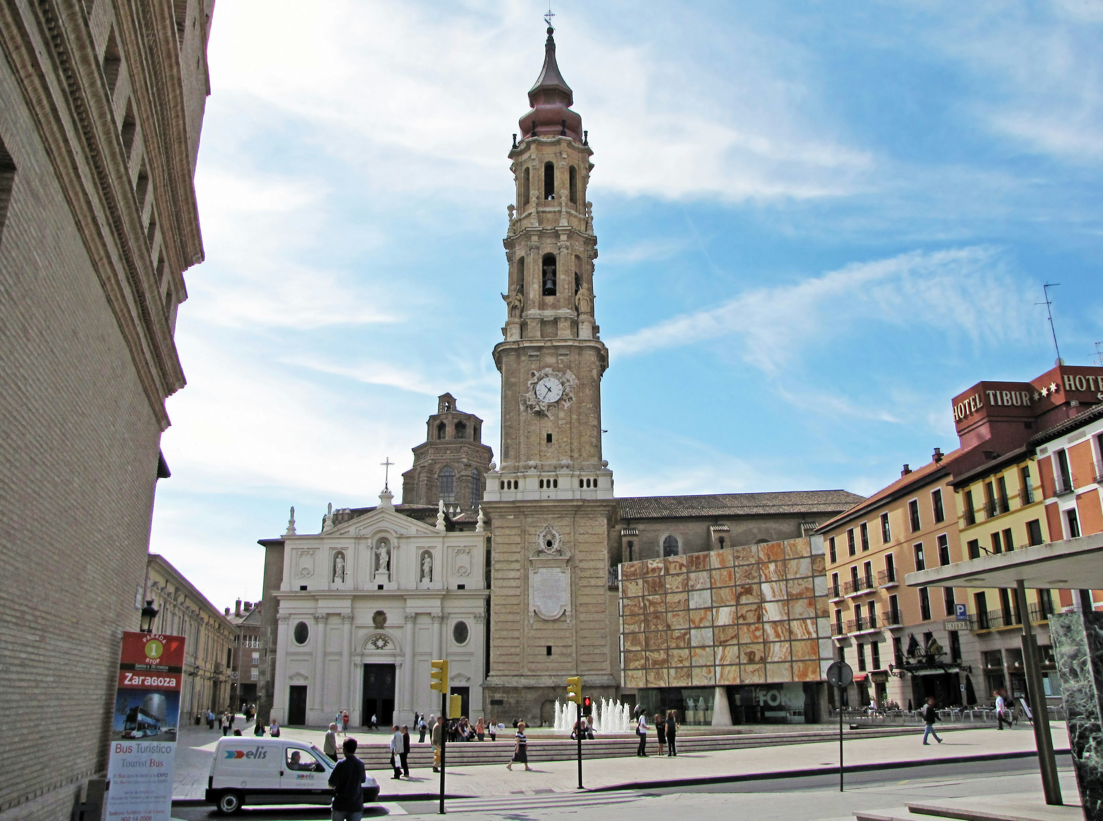 View of a square in Zaragoza Spain featuring a tall clock tower and modern architecture