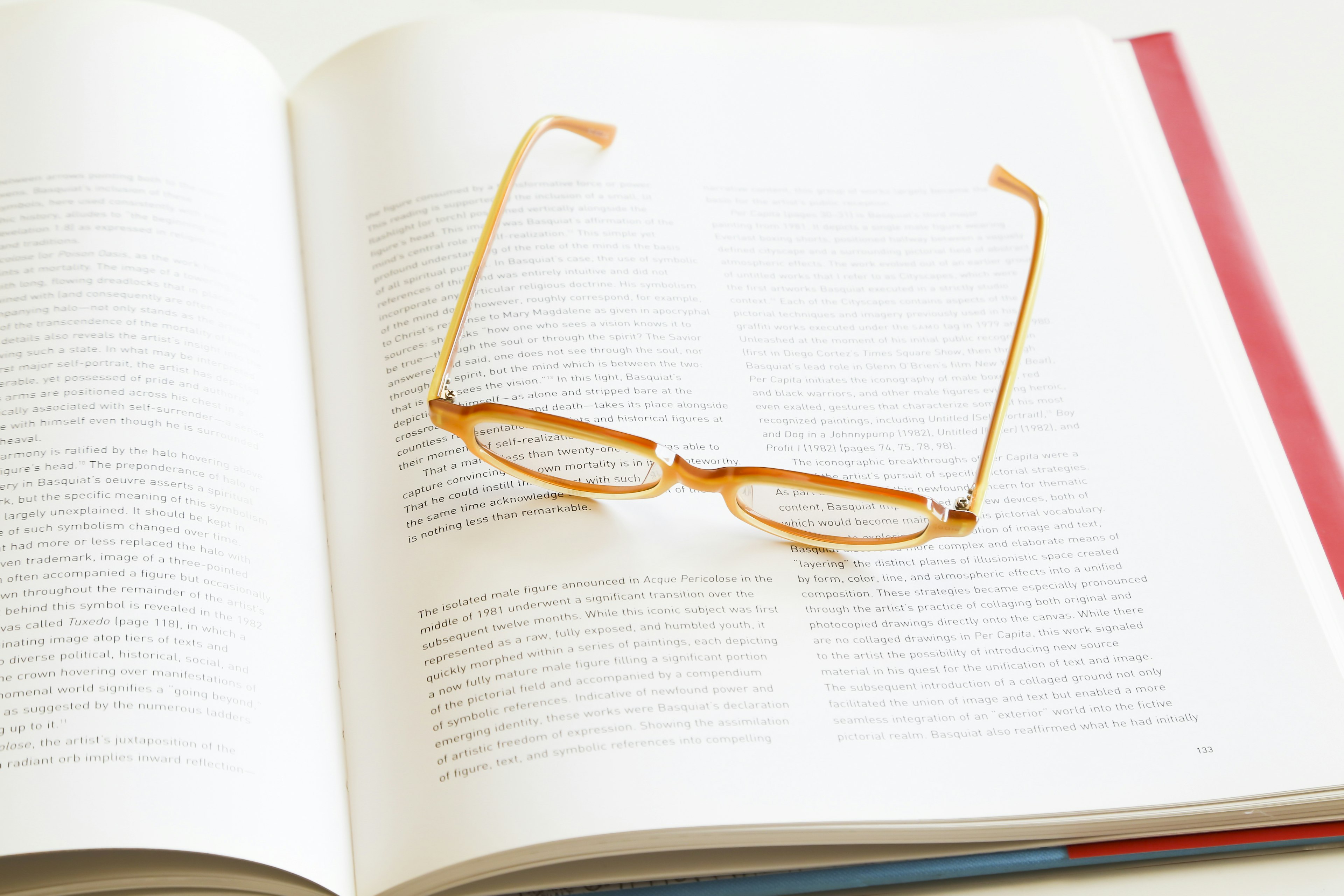 Orange Brille liegt auf einem offenen Buch