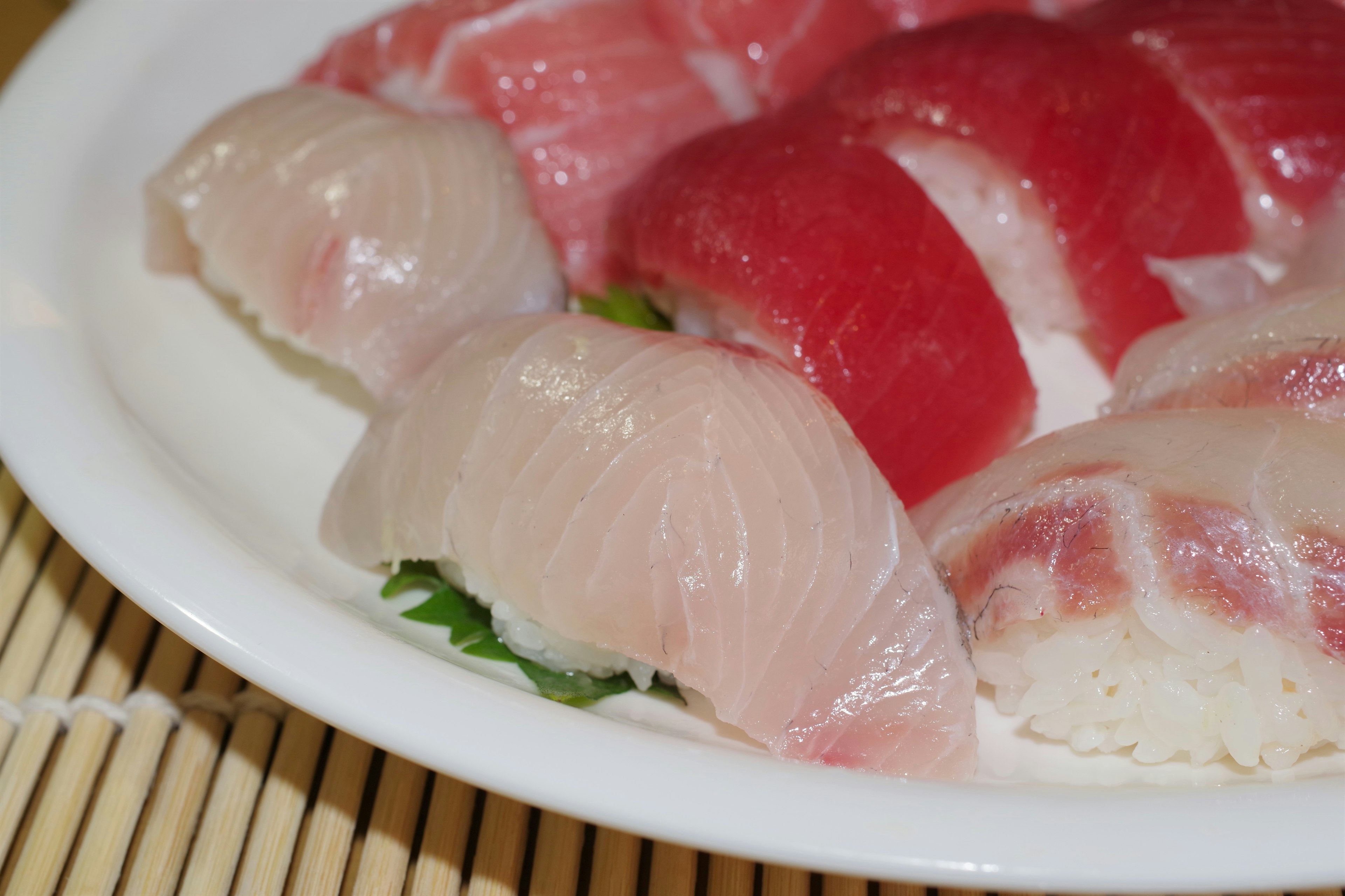 Fresh sushi platter featuring white fish and red fish