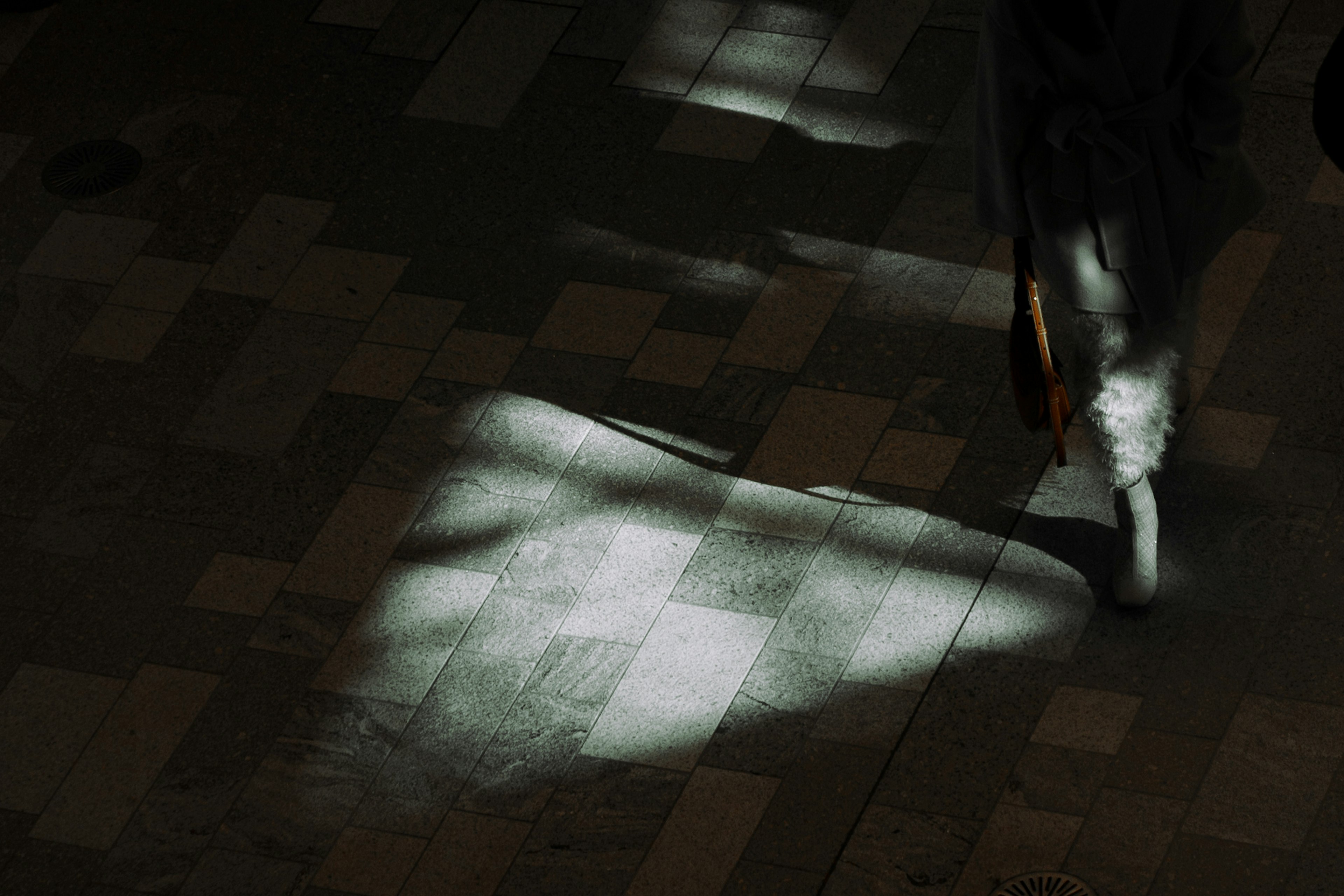 Image featuring contrasting light and shadow in a dark space