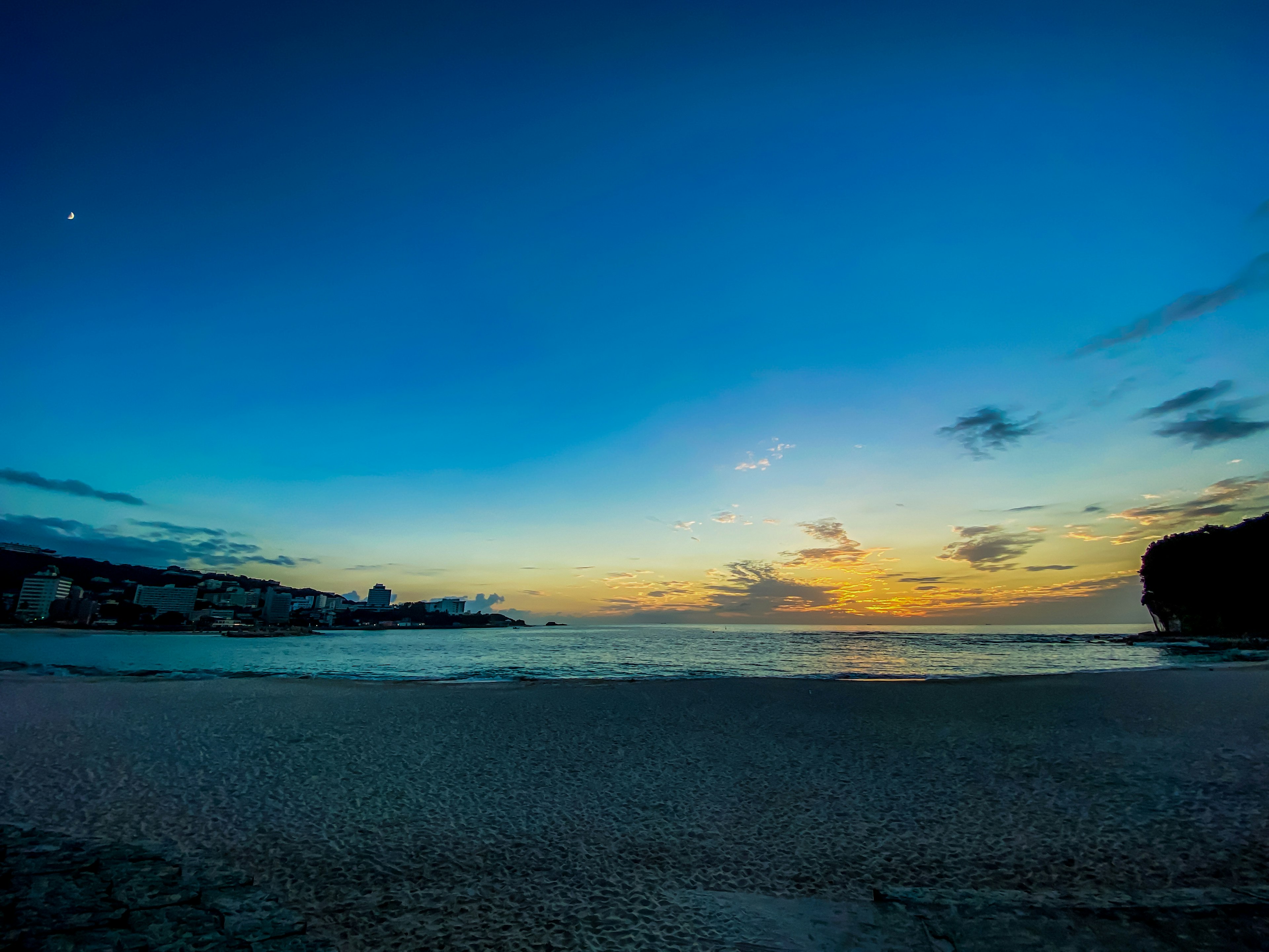 Beautiful beach landscape at sunset with blue sky and clouds moon shining