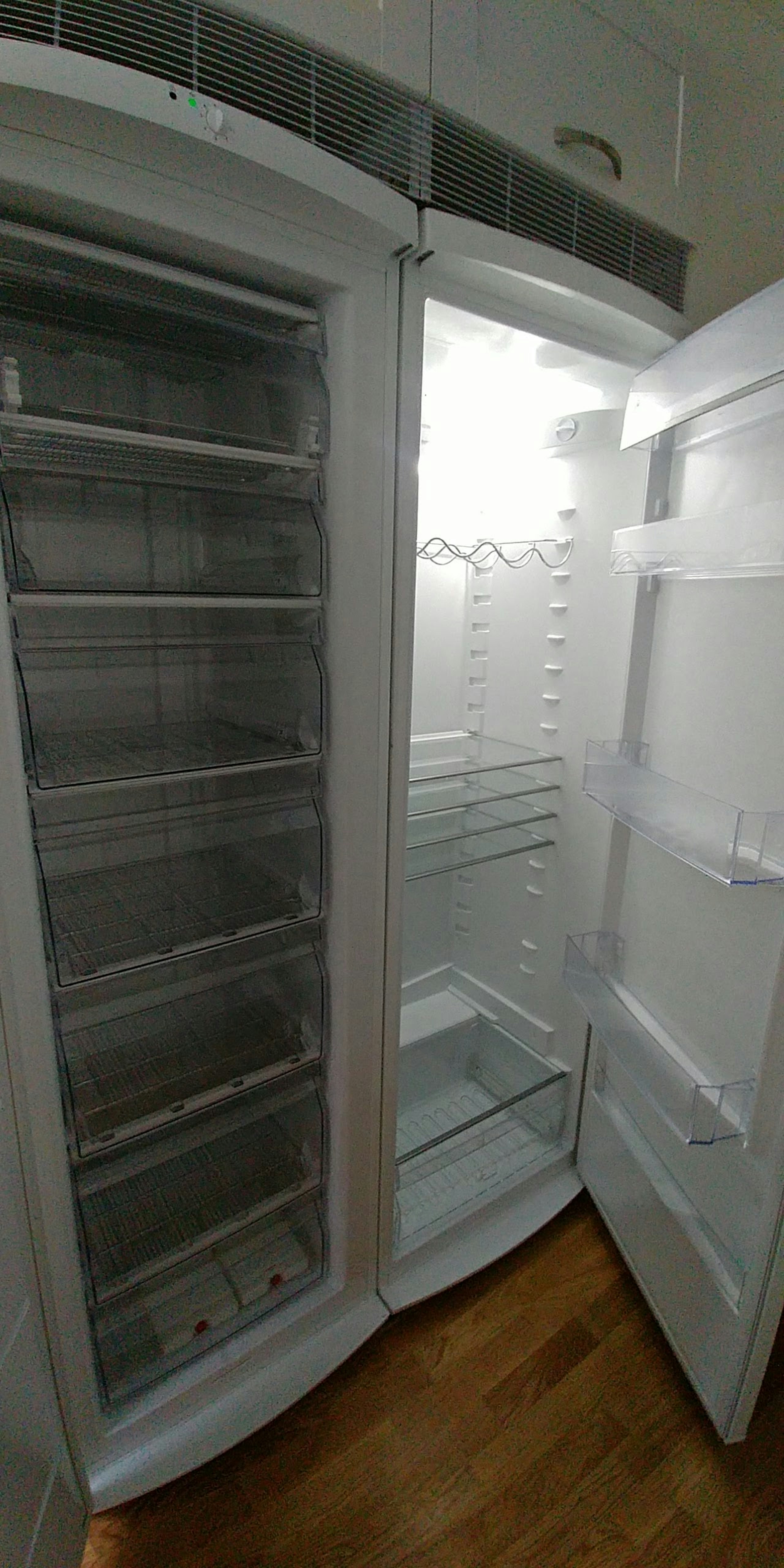 Empty white refrigerator interior with shelves arranged