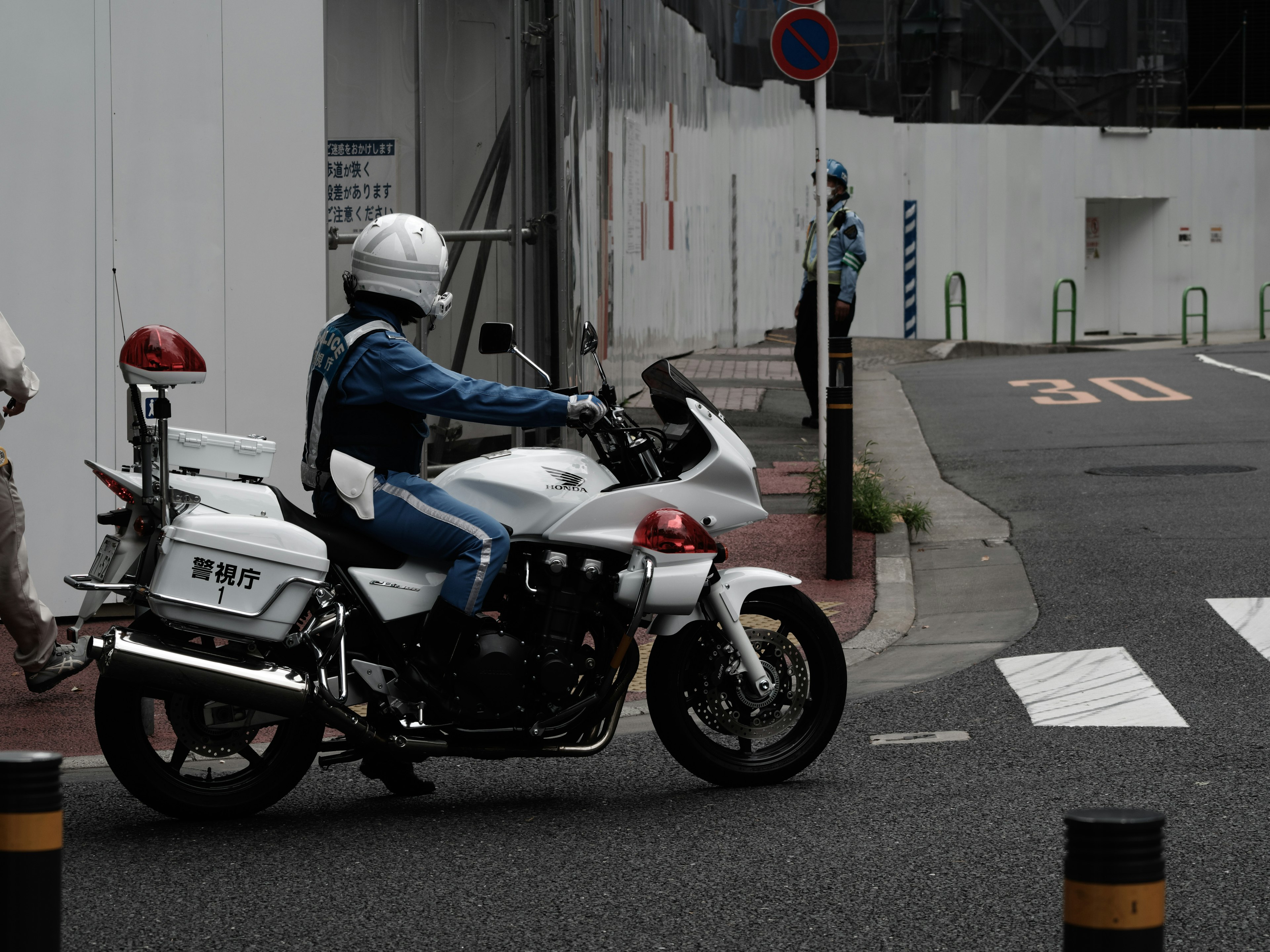 A white police motorcycle turning at an intersection