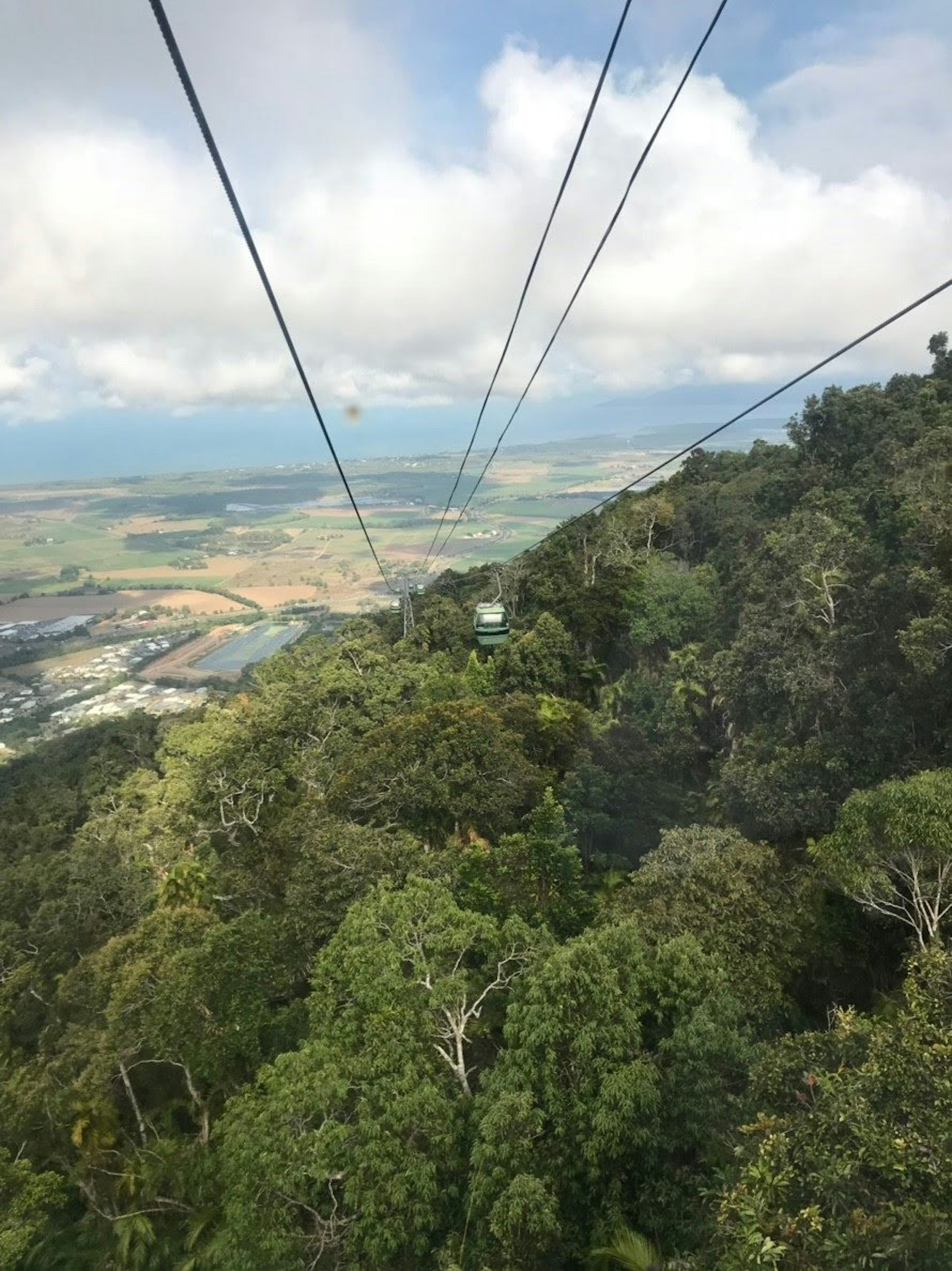 View of lush green mountains and landscape from a cable car