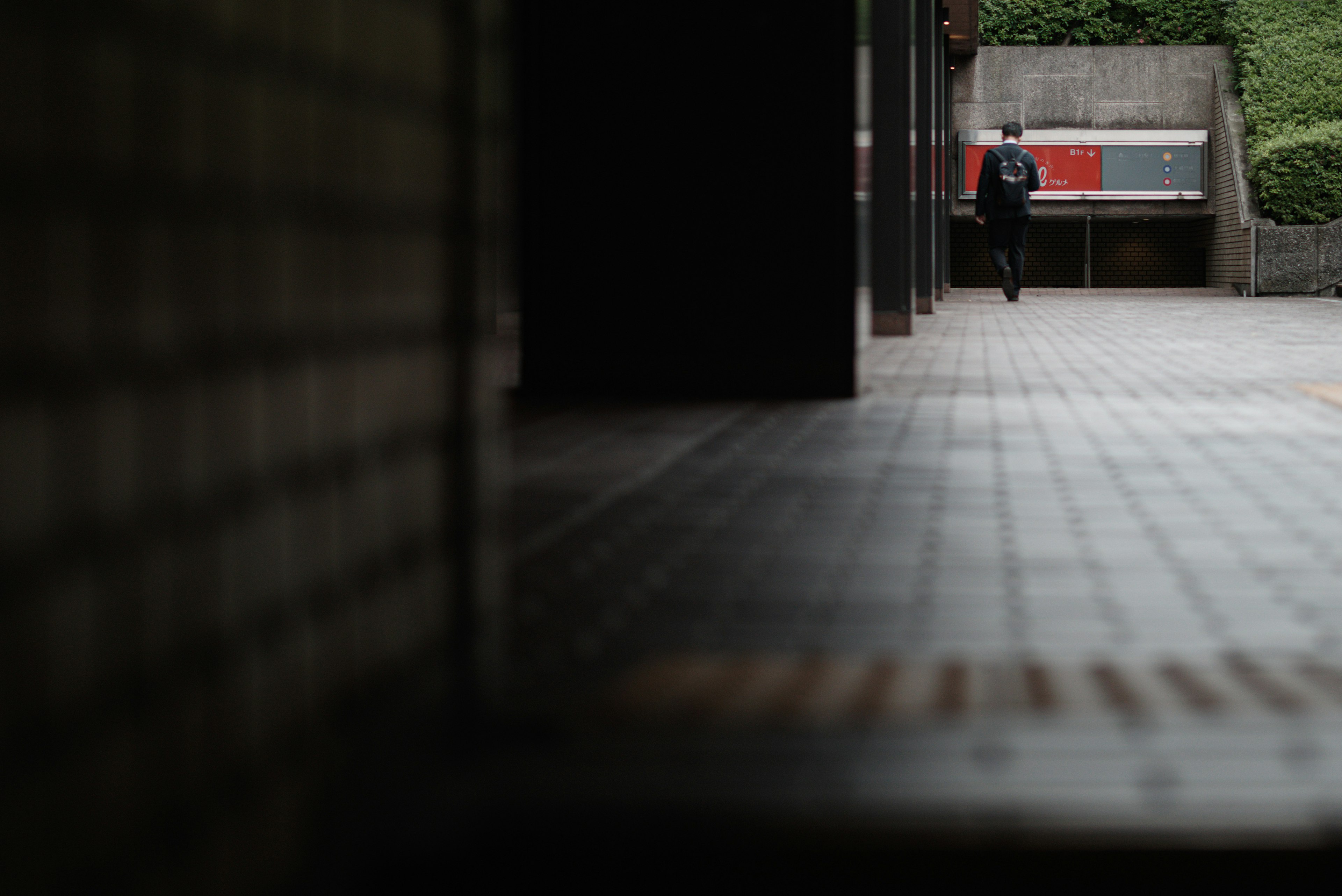 Silhouette of a person walking in a building corridor