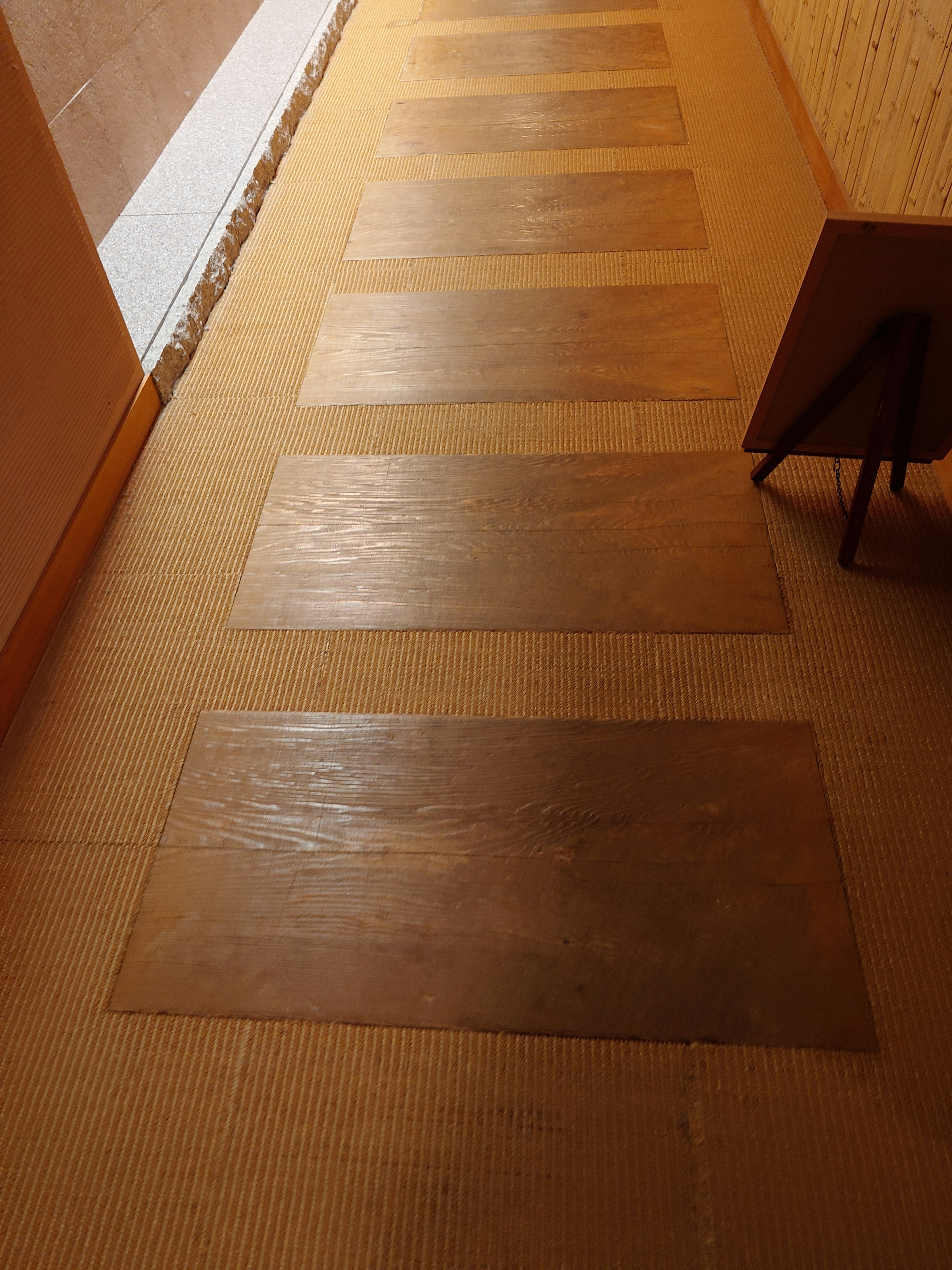 Image of a wooden floored hallway with laid wooden panels